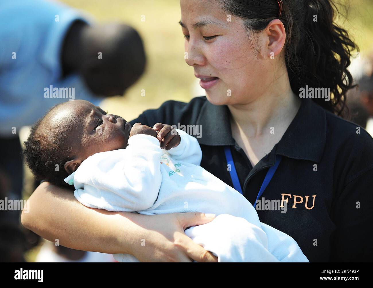 Ein Mitglied der chinesischen Polizeieinheit (FPU) trägt eine 4 Monate alte Waise in Port-au-Prince, der Hauptstadt Haitis, die vom Erdbeben heimgesucht wurde, am 30. Januar 2010. Ein Erdbeben der Stärke 7,3 traf Haiti am 12. Januar 2010. Rettung hat keine nationalen Grenzen. Nicht nur in Nepal waren chinesische Rettungsteams in vielen Gebieten aktiv, die von Erdbeben und anderen Naturkatastrophen in China betroffen waren, ebenso wie ausländische Länder wie Algerien, Iran, Indonesien, Pakistan, Haiti, Neuseeland und Japan.) (lfj) KATASTROPHEN-CHINA RETTUNGSHILFE WuxXiaoling PUBLICATIONxNOTxINxCHN ein Mitglied der chinesischen Polizeieinheit FPU trägt ein 4 Monate altes Stockfoto