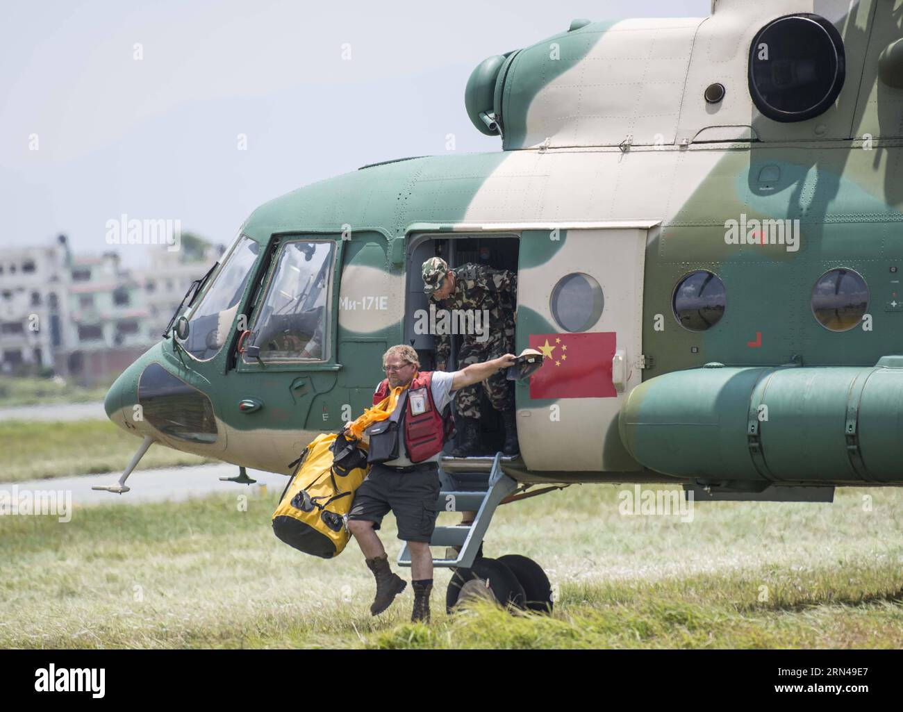 (150513)-- KATHMANDU, 13. Mai 2015--- Ein Arbeiter des Internationalen Roten Kreuzes tritt am 13. Mai 2015 in Kathmandu, der Hauptstadt Nepals, aus einem Hubschrauber einer Armee-Luftfahrt-Brigade der Militärregion Chengdu der Volksbefreiungsarmee Chinas in Kathmandu, aus. Drei chinesische Militärhubschrauber der Brigade evakuierten am Mittwoch 108 Menschen aus verschiedenen Gebieten Nepals, einen Tag nach einem neuen Erdbeben der Stärke 7,5, bei dem mindestens 65 Menschen ums Leben kamen und über 1.900 Menschen verletzt wurden, sagten Beamte. )(azp) NEPAL-KATHMANDU-BAKE-CHINA-HUBSCHRAUBER-RETTUNG LuixSiuxWai PUBLICATIONxNOTxINxCHN 150513 KATHMANDU 13. Mai 201 Stockfoto