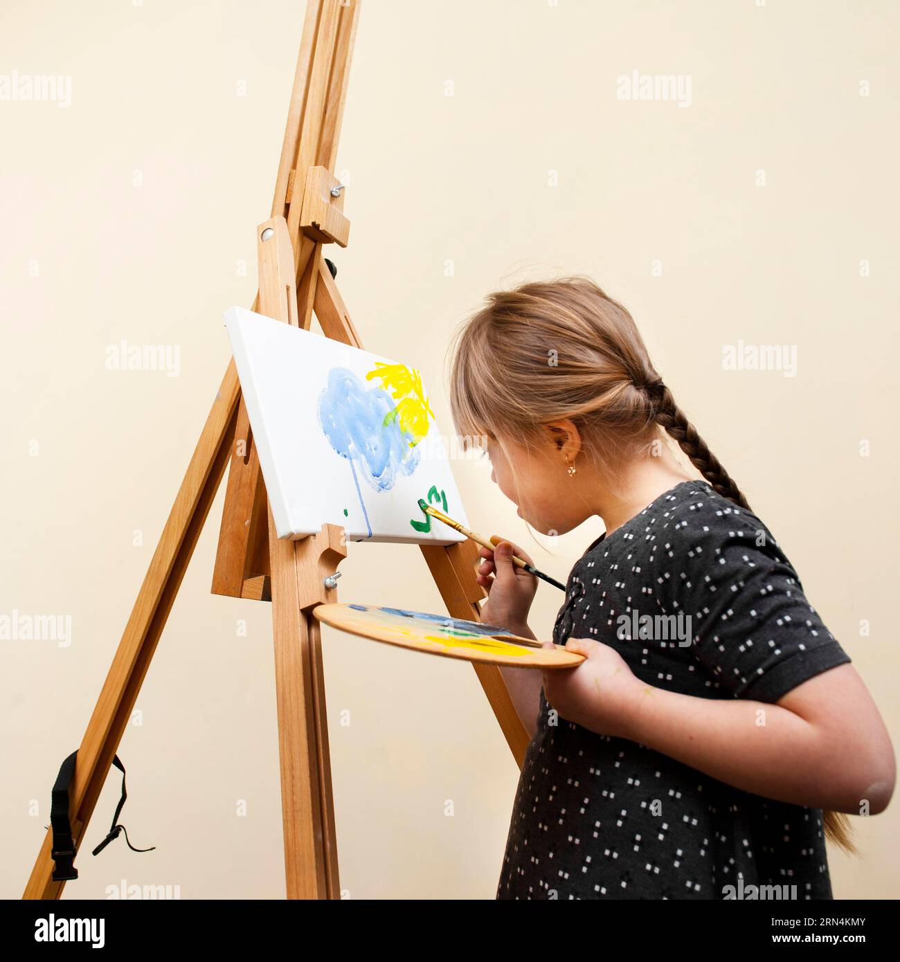 Side View Girl mit Down-Syndrom Malerei mit Pinsel Stockfoto
