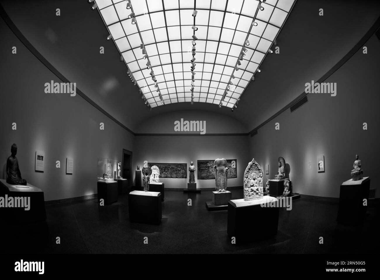 Ausstellung asiatischer Kunst, Freer Gallery of Art, Washington, D.C. Schwarzweiß-Fotografie zeigt Skulpturen und Reliefschnitzereien, die in einer großen Galerie mit einem Raster-Oberlicht ausgestellt sind. Stockfoto