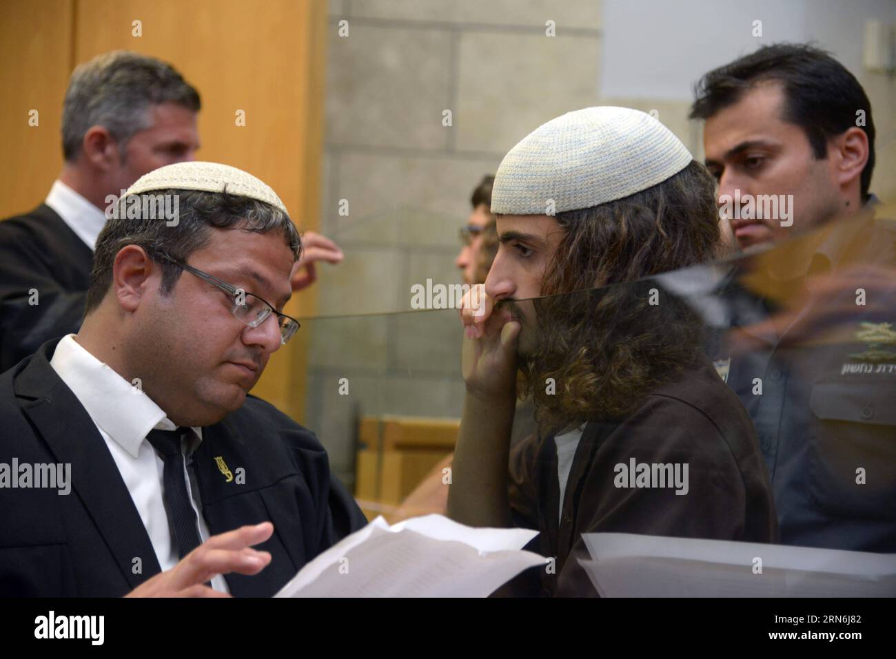 (150729) -- JERUSALEM, 29. Juli 2015 -- Ynon Reuveni (R, Front) wird am 29. Juli 2015 am Nazareth Magistrate’s Court in Israel gesehen. Zwei rechtsextreme jüdische Jugendliche wurden am Mittwoch angeklagt, weil sie im vergangenen Monat bei einem der schwersten antichristlichen Angriffe in Israel eine berühmte katholische Kirche angezündet hatten, sagten israelische Beamte am Mittwoch. Laut der Anklage, die vor dem Gericht des Magistrats von Nazareth, Ynon Reuveni, 20, und Yehuda Assraf, 19, erhoben wurde, waren Teil einer Gruppe, die die Vermehrung der Brote- und Fischkirche am Galiläischen Meer in Nordisrael am 18. Juni in Brand setzte. Die Kirche markiert Th Stockfoto