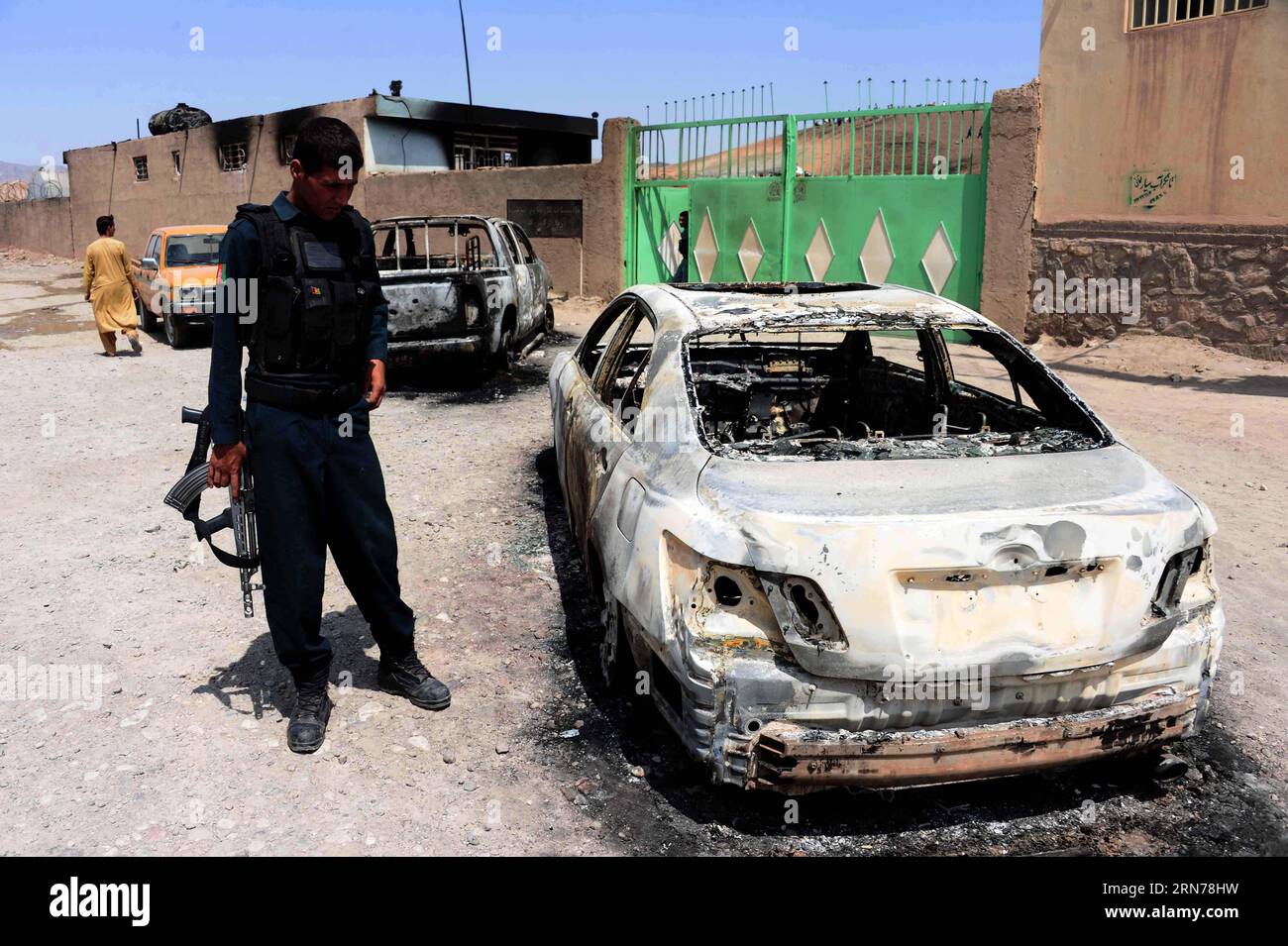 (150825) -- HERAT, 25. August 2015 -- ein afghanischer Polizist steht neben verbrannten Fahrzeugen nach einer Gastanker-Explosion in der Provinz Herat, Westafghanistan, 25. August 2015. Mindestens 11 Menschen wurden getötet, während 18 andere verwundet wurden, nachdem ein Flüssiggasreservoir in Herat City, der Hauptstadt der westafghanischen Provinz Herat, über Nacht am Montag in Brand geraten war, sagten Quellen am Dienstag. ) AFGHANISTAN-HERAT-GAS-FEUER-EXPLOSION Sardar PUBLICATIONxNOTxINxCHN 150825 Herat Aug 25 2015 zu afghanischer Polizist steht neben verbrannten FAHRZEUGEN nach einer Gastanker-Explosion in der Provinz Herat Westafghanistan Aug 25 Stockfoto