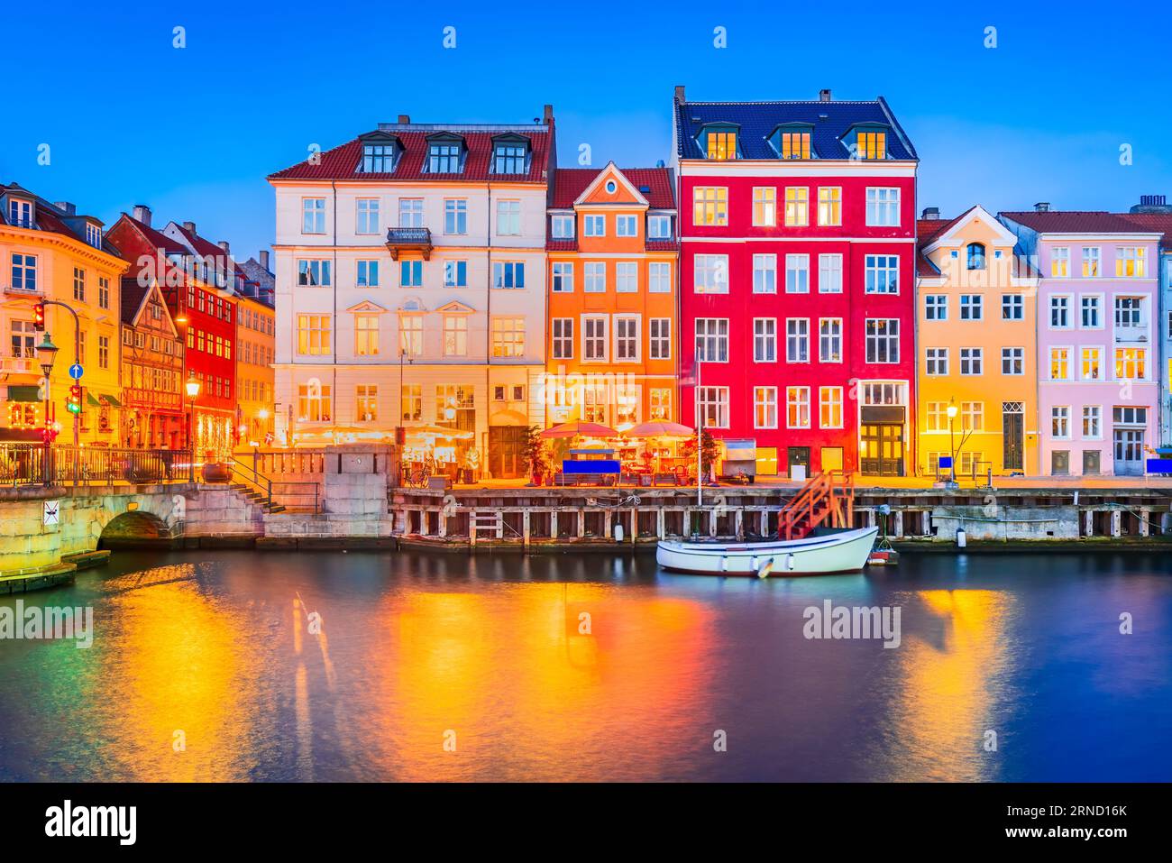 Der Charme von Kopenhagen, Dänemark in Nyhavn. Legendärer Kanal, farbenfrohes Nachtbild und atemberaubende Wasserreflexionen. Stockfoto