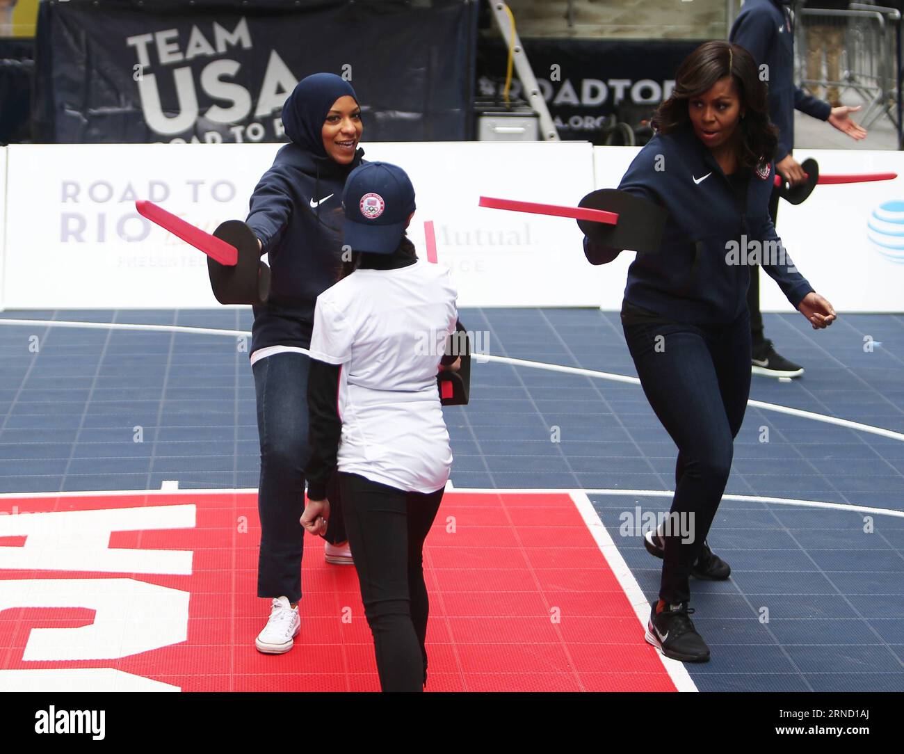 NEW YORK, 27. April 2016 -- die US-First Lady Michelle Obama (1. R) nimmt am 27. April 2016 am Times Square in New York, USA, an der Fechtdemonstration Teil. Die „Road to Rio Tour“ des Teams USA fand am Mittwoch auf dem Times Square statt, um den 100-tägigen Countdown zu den Olympischen Spielen 2016 in Rio de Janeiro zu feiern. Mehr als 70 olympische und paralympische Athleten nahmen an der Veranstaltung Teil und teilten ihren Geist und ihre Begeisterung für die Spiele mit den Fans hier. ) U.S.-NEW YORK-OLYMPIC GAMES-100 DAYS-COUNTDOWN Qinxlang PUBLICATIONxNOTxINxCHN New York 2. April Stockfoto