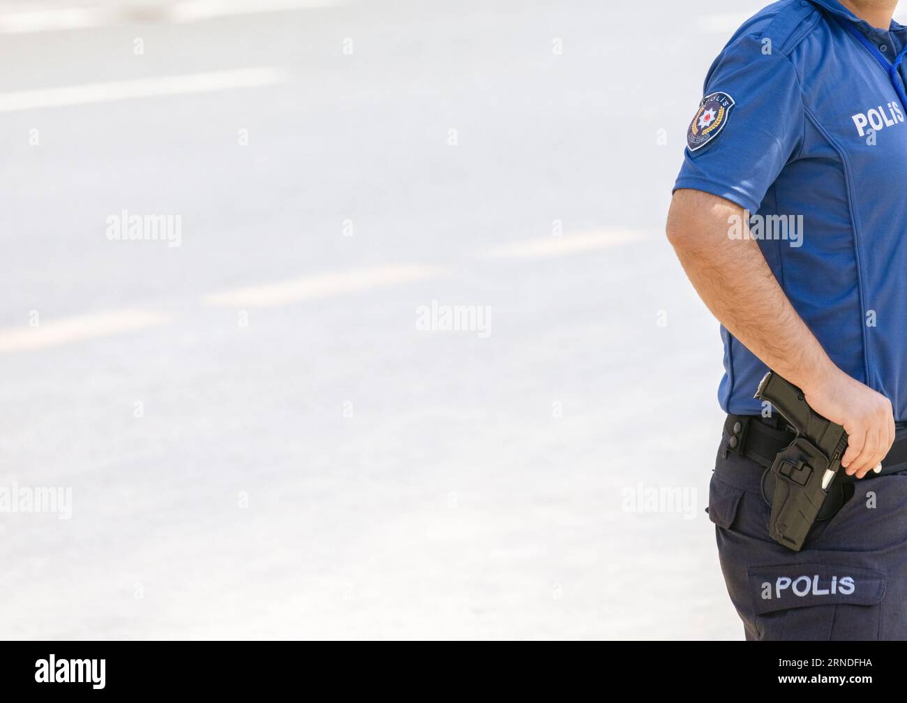 Nahaufnahme des Leichnams eines türkischen Polizeiamtes mit einer Waffe auf der Straße. Großer Kopierbereich links. Stockfoto