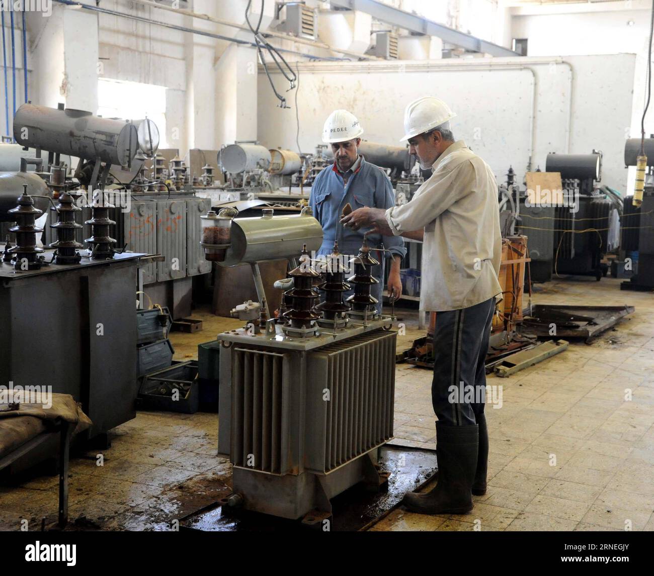 (160622) -- DAMASKUS, 22. Juni 2016 -- Elektrizitätsarbeiter versuchen, Elektrizitätstransformatoren in einem Kraftwerk zu reparieren, das am 22. Juni 2016 in der Stadt Adra al-Omaliyeh, der syrischen Hauptstadt Damaskus, von mit al-Qaida verbundenen Militanten sabotiert wurde. Die syrische Armee eroberte Adra al-Omaliyeh im Jahr 2014 zurück, und seitdem wird die Infrastruktur instand gesetzt. ) SYRIEN-DAMASKUS-ELEKTRIZITÄTSWERK Ammar PUBLICATIONxNOTxINxCHN 160622 Damaskus 22. Juni 2016 Elektrizitätsarbeiter versuchen, Elektrizitätstransformatoren in einem Kraftwerk zu reparieren, das von Al-Kaida-Militanten in der Stadt Ad sabotiert wurde Stockfoto