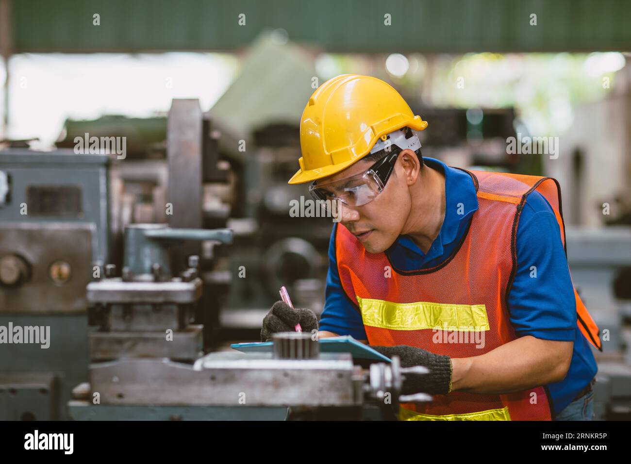 Asiatischer Fachtechniker Ingenieur männlich Focus Detail arbeiten Präzisions-Handschnitt Fräsen Metallproduktion in der Schwerindustrie Stockfoto