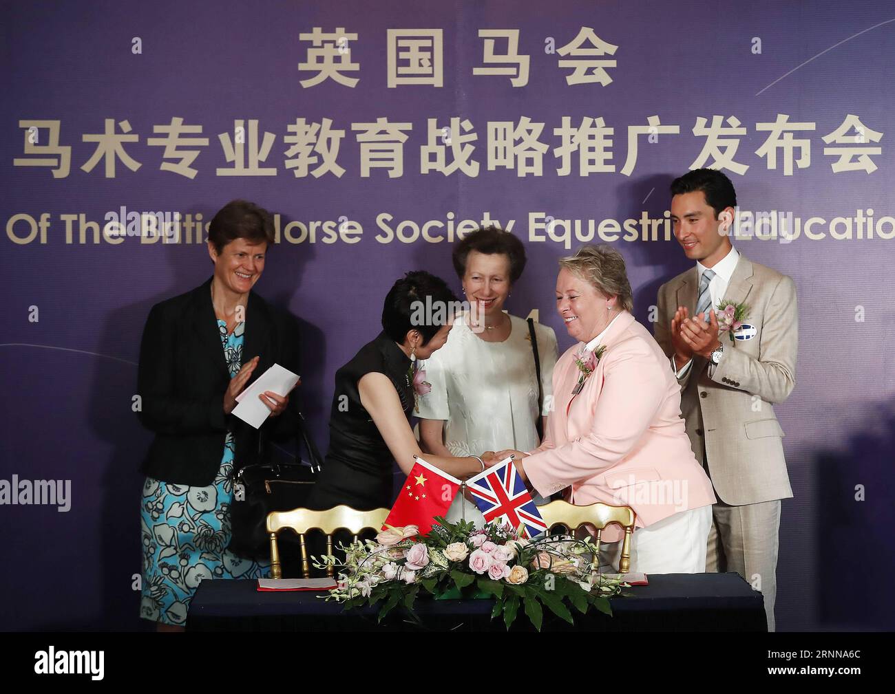 (170704) -- PEKING, 4. Juli 2017 -- CEO der British Horse Society (BHS) Lynn Petersen (Front R) und Michelle Wang (Front L), Direktorin und General Manager des Equuleus International Riding Club, schütteln sich die Hände nach der Unterzeichnung des Vertrags als britische Botschafterin in China Barbara Woodward (Rear L), britische Prinzessin Anne (Rear Center) und BHS-Botschafter, chinesischer Reiter Alex Hua Tian, Zeuge einer Pressekonferenz zur Eröffnung des Equestrian Education Project der British Horse Society in der britischen Botschaft in Peking, Hauptstadt Chinas, 4. Juli 2017.) (SP)START DES PROJEKTS CHINA-BEIJING-EQUESTRIAN-BHS-EDUCATION (CN) Stockfoto