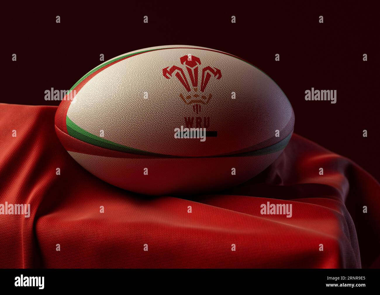 2. September 2023 - Bristol, Großbritannien: Ein 3D-Bild eines Rugby-Balls mit dem Aufdruck des Wales Rugby-Logos auf einem drapierten roten Stoff Stockfoto