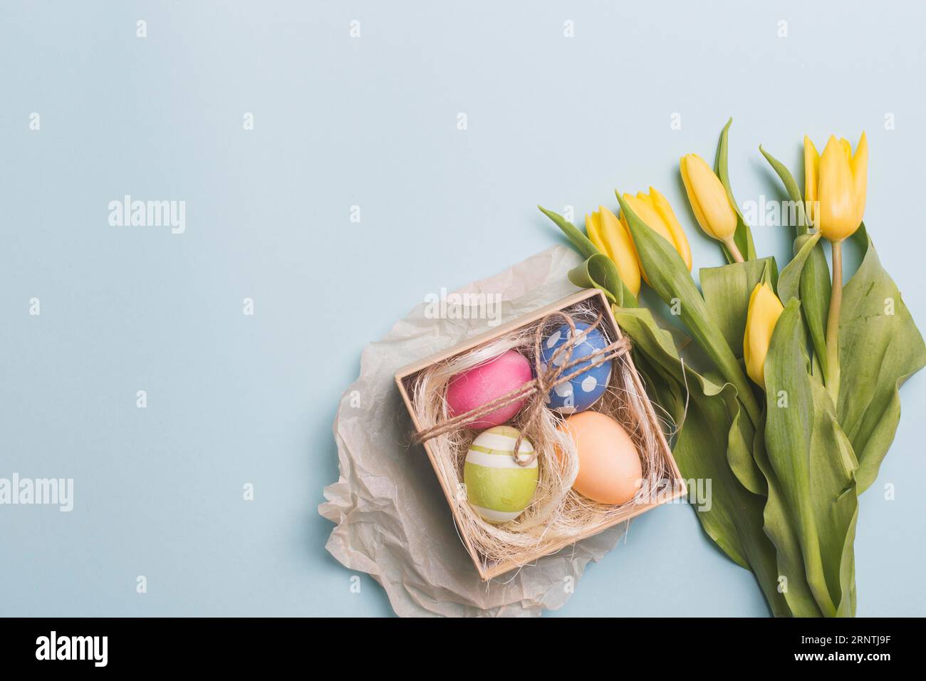 Box mit Eiern in der Nähe von Tulpen blau Stockfoto