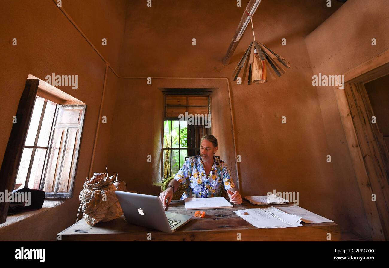 (181023) -- HAIKOU, 23. Oktober 2018 -- der Kanadier Craig Anderson arbeitet auf der Westinsel in Sanya, Südchinesische Provinz Hainan, 20. September 2018. Anderson kam im Februar auf der West Island an, wo etwa 4.000 Menschen lebten. Die Einheimischen betrachteten Anderson als einen Schnitzer, als er zum ersten Mal ankam, als er fast jeden Tag am Strand umherwanderte und Treibholz, Plastikflaschen, zerbrochene Gläser und rostige Eisenstücke aufnahm. Im Laufe der Zeit erkannten die Einheimischen, dass Anderson ein Künstler ist, der sich dem Umweltschutz widmet. Er profitiert von den recycelbaren und regenerativen Materialien Stockfoto