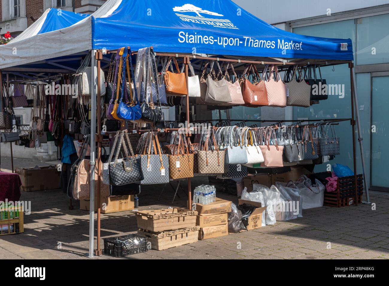 Straßenmarkt im Freien im Stadtzentrum von Staines-upon-Thames, Surrey, England, Großbritannien. Marktstand, der Taschen, Handtaschen verkauft Stockfoto