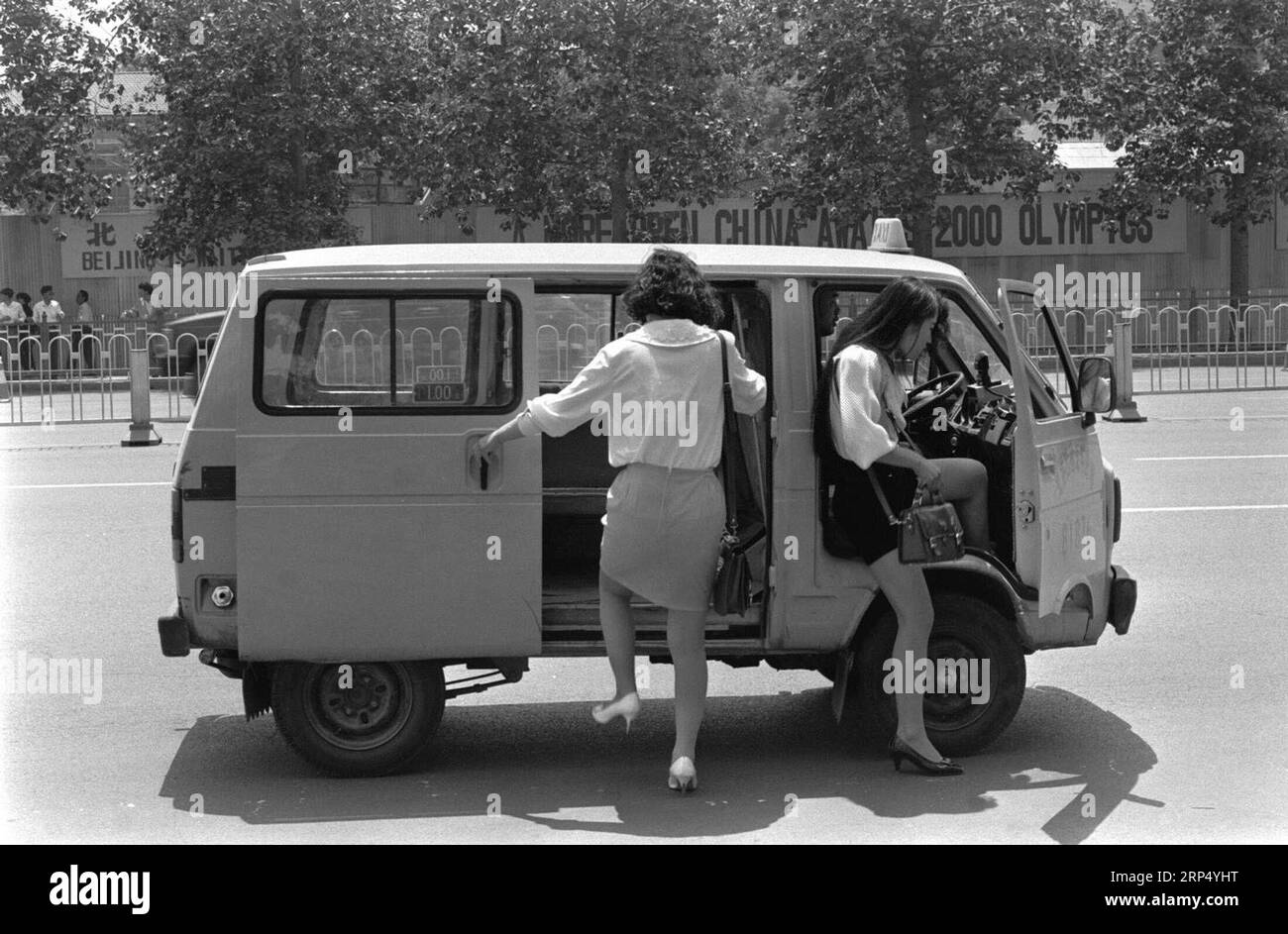 (181121) -- PEKING, 21. November 2018 () -- das 1993 aufgenommene Foto zeigt zwei junge Damen, die in Peking, der Hauptstadt Chinas, ein Taxi nehmen. Seit 1978, als China seine Reform- und Öffnungspolitik begann, wurde eine Tür nach außen geöffnet. Zusammen mit den importierten Waren rutschten die Modeideen unweigerlich nach China, und seitdem begann das Land, das ein wenig an modischer Vielfalt mangelte, seine Reise, um der Mode nachzugehen. In den letzten vier Jahrzehnten hat der Durst nach Schönheit die Chinesen dazu gebracht, alle denkbaren modischen Elemente zu verfolgen. Das Wechselgeld kam zuerst mit dem Kleid, wann Stockfoto