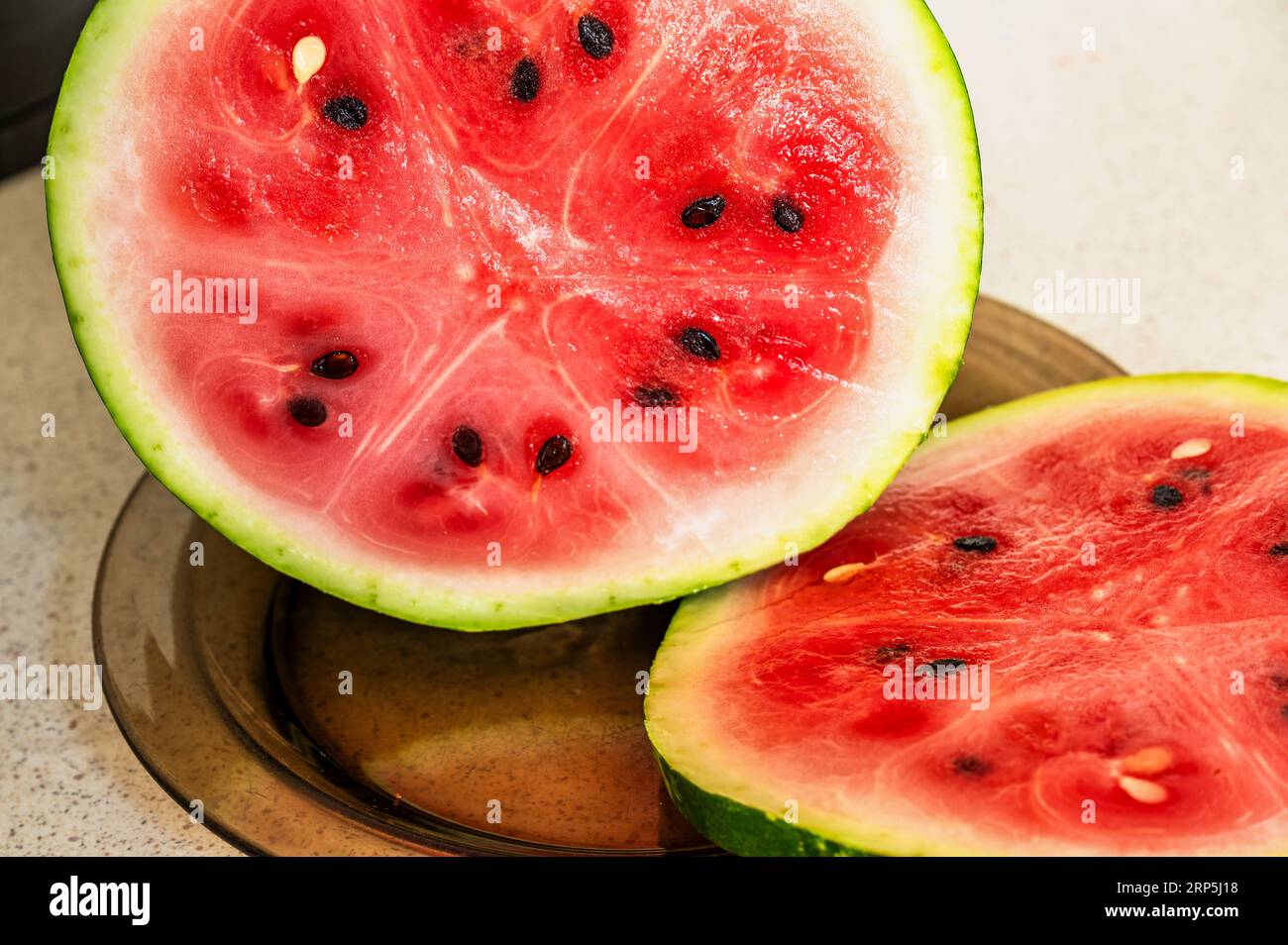 Geschnittene Wassermelone auf braunem Teller, Nahaufnahme. Stockfoto
