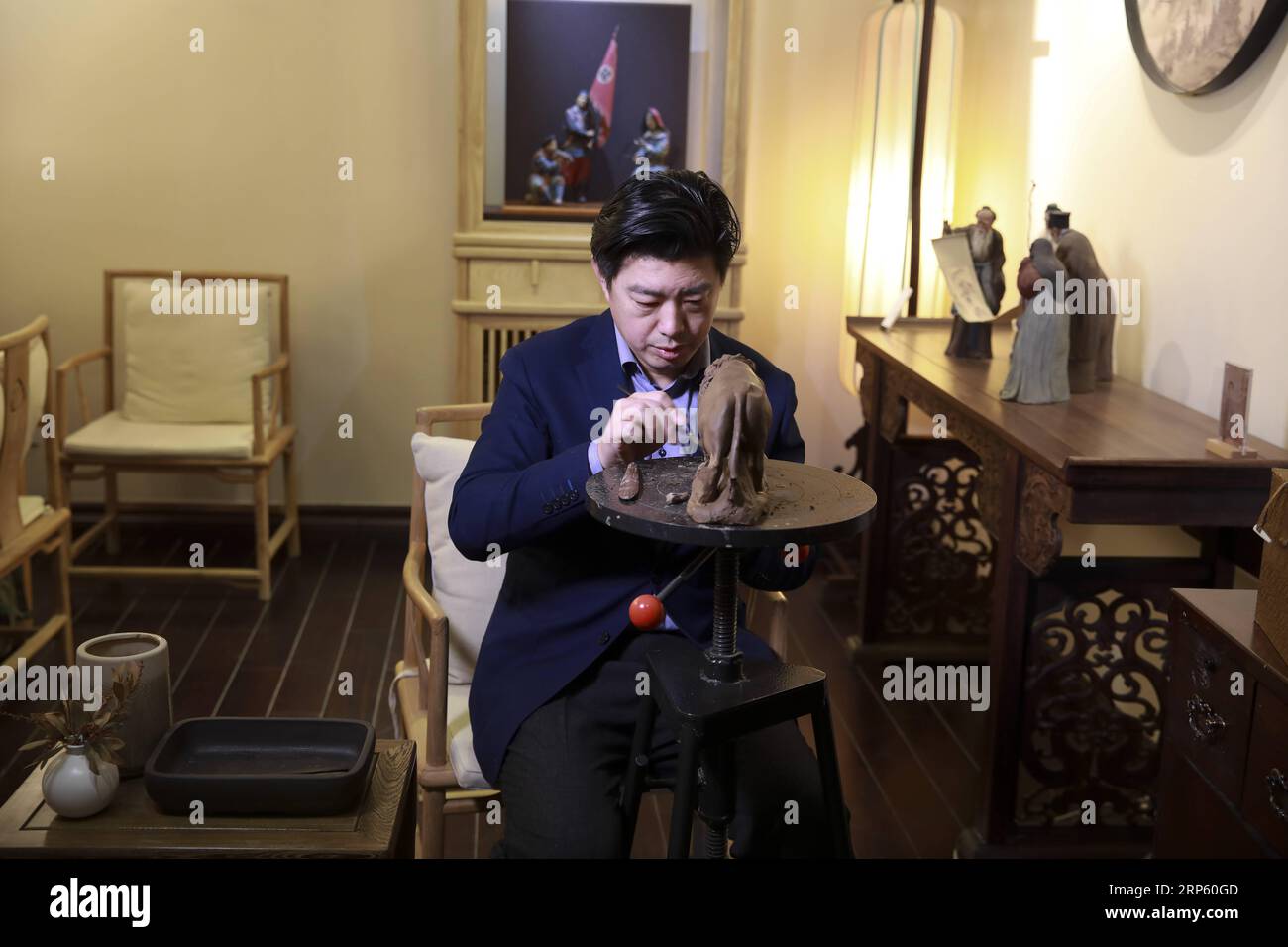 (181229) -- PEKING, 29. Dezember 2018 (Xinhua) -- Zhang Yu, der sechste Generation Hersteller von Tonfiguren Zhang, knabbert eine Figur in seiner Werkstatt in der Tonfiguren Zhang Kunstgalerie in Tianjin, Nordchina, 28. Dezember 2018. Clay Figure Zhang ist ein bekannter Name für traditionelle Volkskunst in China, und solche Kunstwerke haben eine Geschichte von fast 200 Jahren. Zhang Yu, der sechste Generation von Tonfiguren in seiner Familie, übernahm das Familienunternehmen 1996, als er gerade einmal 18 Jahre alt war. Mit der Zeit haben sich Handwerk und Marke weiterentwickelt. Anstatt Figuren zu machen und sie wie ein Straßenverkäufer zu verkaufen, hie Stockfoto