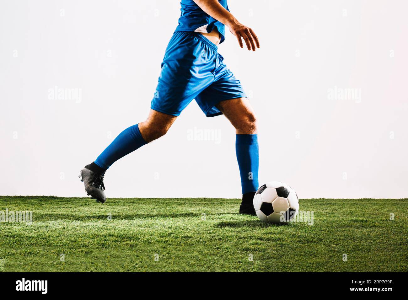 Crop Football Player Shooting Ball Stockfoto