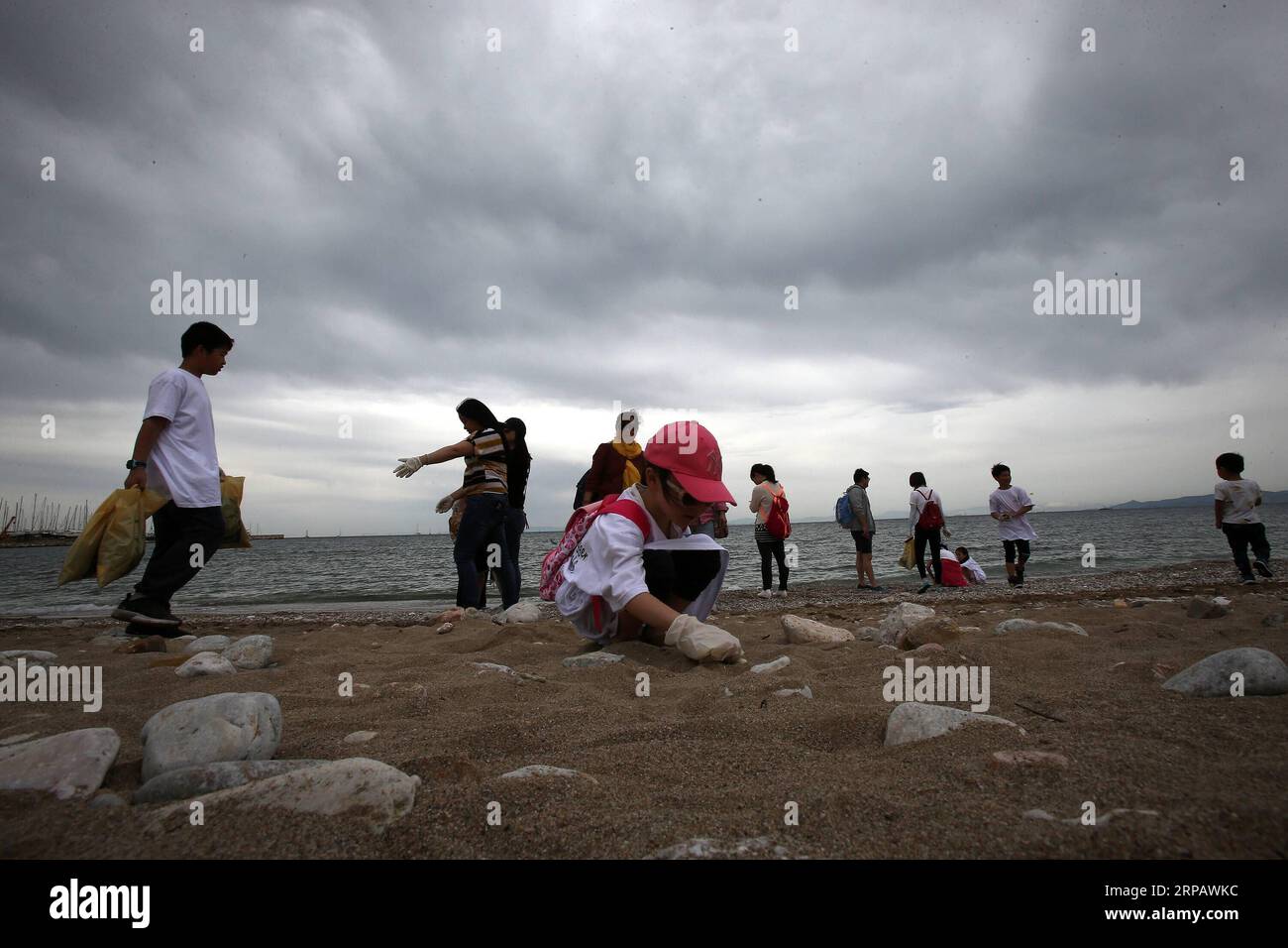 (190519) -- ATHEN, 19. Mai 2019 -- Freiwillige reinigen am 19. Mai 2019 den Strand Palaio Faliro im Süden Athens, Griechenland. Die Chinesen in Griechenland erhielten am Sonntag das herzliche Lob der Athener, weil sie die Initiative ergriffen haben, einen beliebten Strand an der Südküste der Hauptstadt aufzuräumen. Dutzende von Mitgliedern der chinesischen Gemeinschaft, aller Altersgruppen und Berufe, bewaffnet mit Handschuhen und Abfalltüten, überfluteten den Strand von Palaio Faliro, um Plastikhüllen, Flaschenverschlüsse und Zigarettenstummel aufzufangen, die von Schwimmern zurückgelassen oder vom Wind mitgetragen wurden. ) GRIECHENLAND-ATHEN-STRAND-FREIWILLIGE-REINIGUNG MARIOSXLOLOS PUBLICATIONXNOTXINXCHN Stockfoto