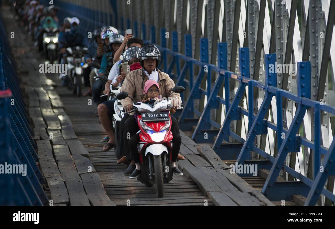 (190608) -- WEST JAVA, 8. Juni 2019 -- Motorradabreisenden passieren am 8. Juni 2019 einen hölzernen Übergang unter der Eisenbahnbrücke Cirohang in Ciamis, West Java, Indonesien. ) INDONESIEN-WEST JAVA-PENDLER-ALLTAG REZAXESTILY PUBLICATIONXNOTXINXCHN Stockfoto