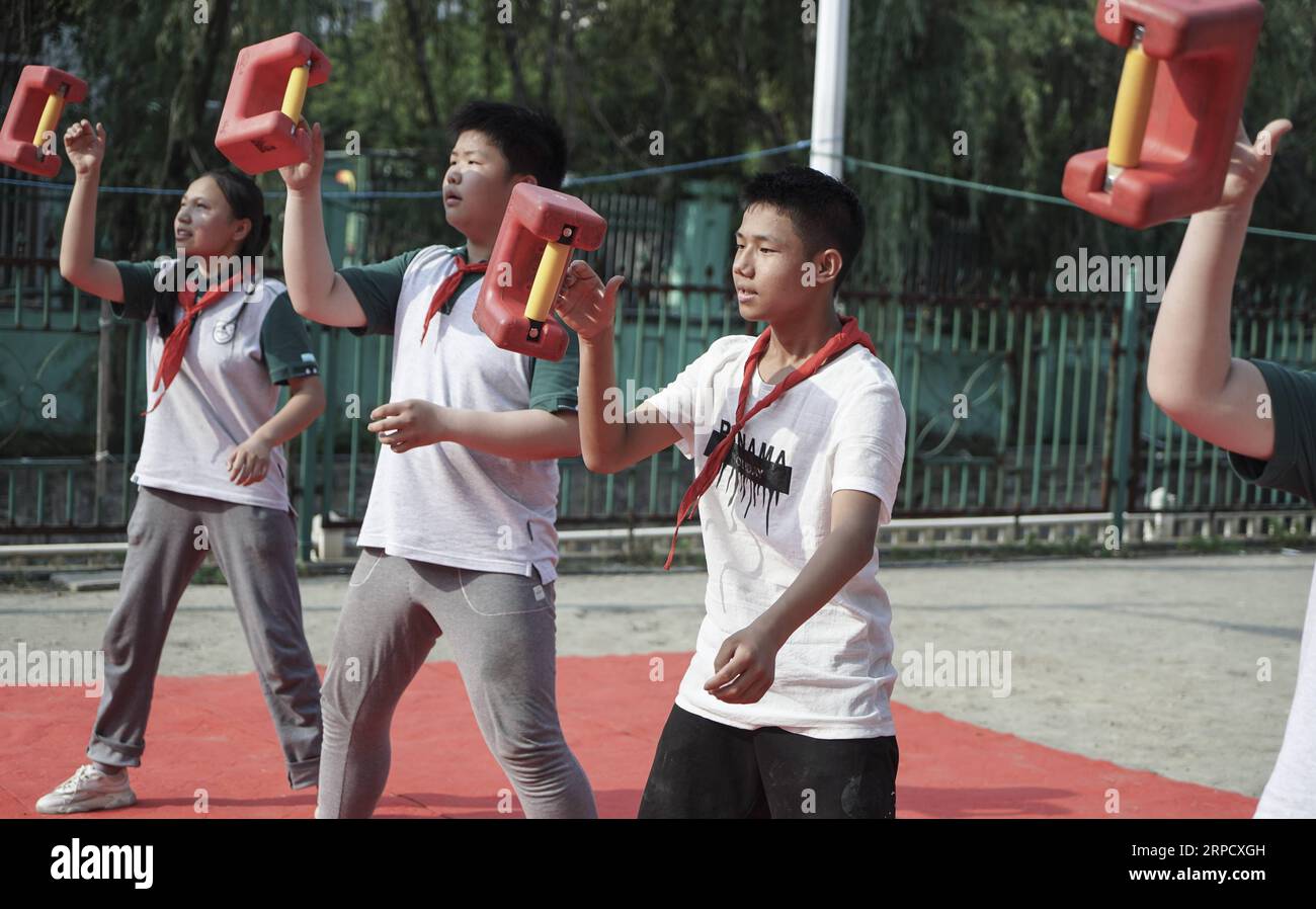 (190715) -- NANJING, 15. Juli 2019 -- Ma Guoliang (3. L) und seine Teammitglieder üben Shisuo-Übung an der Qingshuiting Primary School in Nanjing, ostchinesische Provinz Jiangsu, 4. Juni 2019. Die Schule hat einen Shisuo-Club mit 12 Schülern von der dritten bis zur sechsten Klasse. Shisuo (Steinschloss), eine Steinhantel in Form eines alten Vorhängeschlosses, wird normalerweise in der traditionellen chinesischen Trainingsroutine gesehen. Mit Hunderten von Workout-Moves kann Shisuo nicht nur die Kraft steigern, sondern auch die Koordination von Händen, Augen und Körper fördern. Shisuo geht auf die Tang-Dynastie zurück, in der es so war Stockfoto