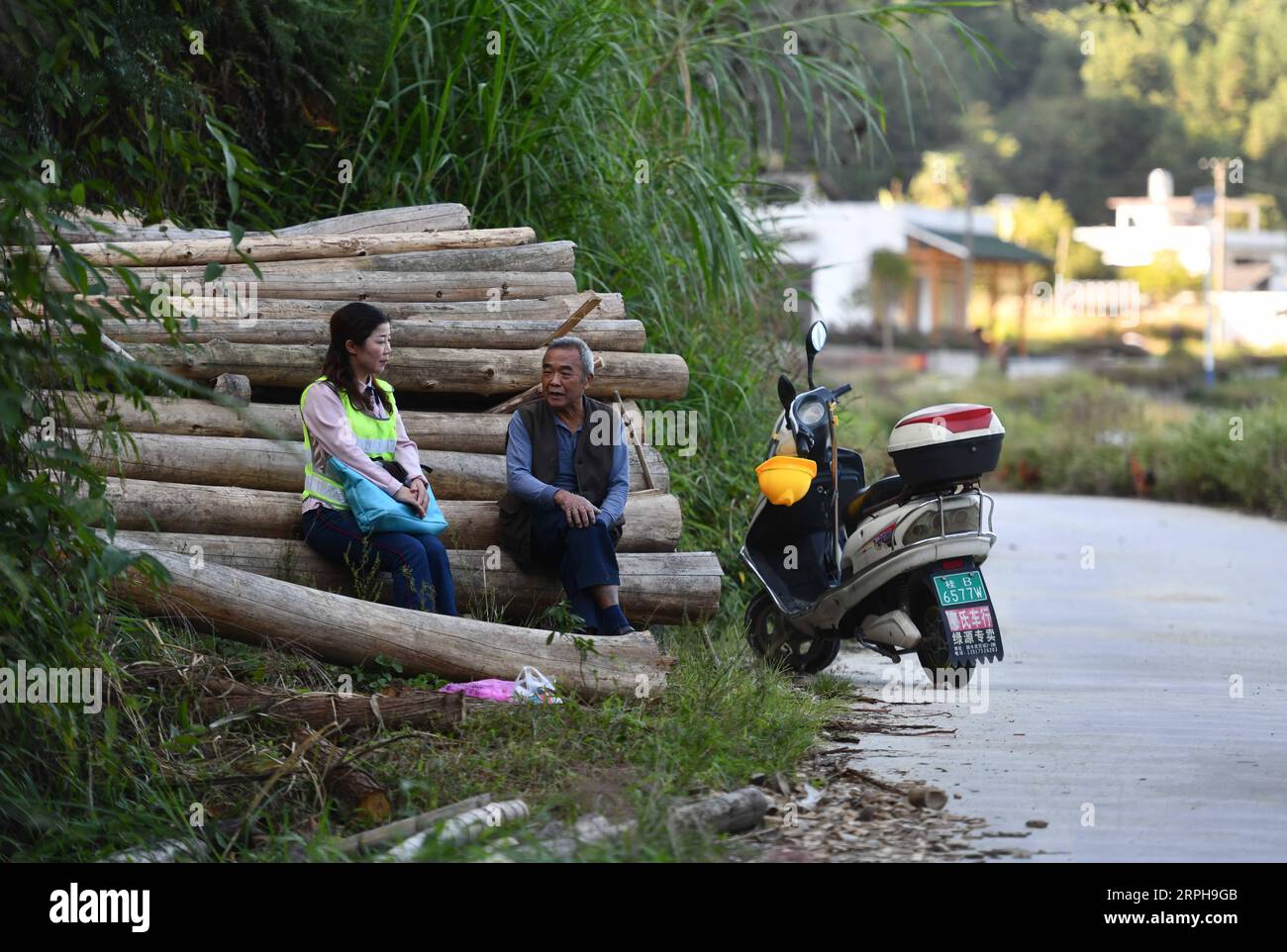 191102 -- RONGSHUI, 2. November 2019 -- der offizielle Wei Yujun L spricht mit einem Dorfbewohner im Dorf Dafang, Xiangfen Township von Rongshui Miao Autonomous County von Liuzhou, südchinesische autonome Region Guangxi Zhuang, 31. Oktober 2019. In der Gemeinde Xiangfen spielten sieben weibliche Beamte in den letzten Jahren eine aktive Rolle an der Spitze der lokalen Armutsbekämpfungskampagnen und wurden von der lokalen Bevölkerung als sieben goldene Blumen bezeichnet. Sie nutzen Motorräder, Elektrofahrräder und Fahrräder als Transportmittel, um Dorfbewohner auf dem Land zu besuchen und Armutsbekämpfung zu leisten. Abou Stockfoto