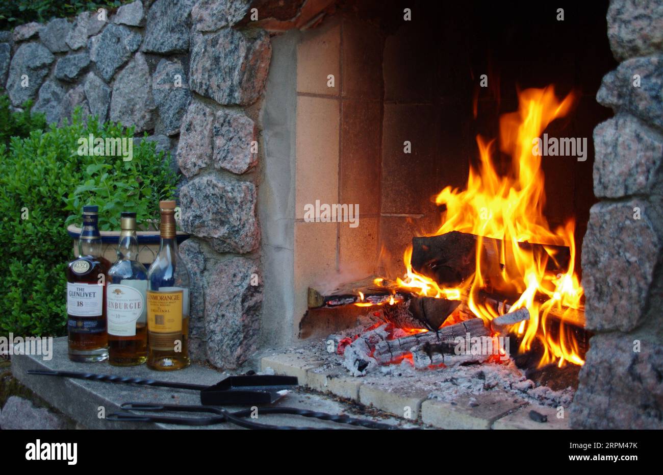 Kristiansand, Norwegen, Flaschen Scotch Whisky draußen am offenen Feuer. Stockfoto