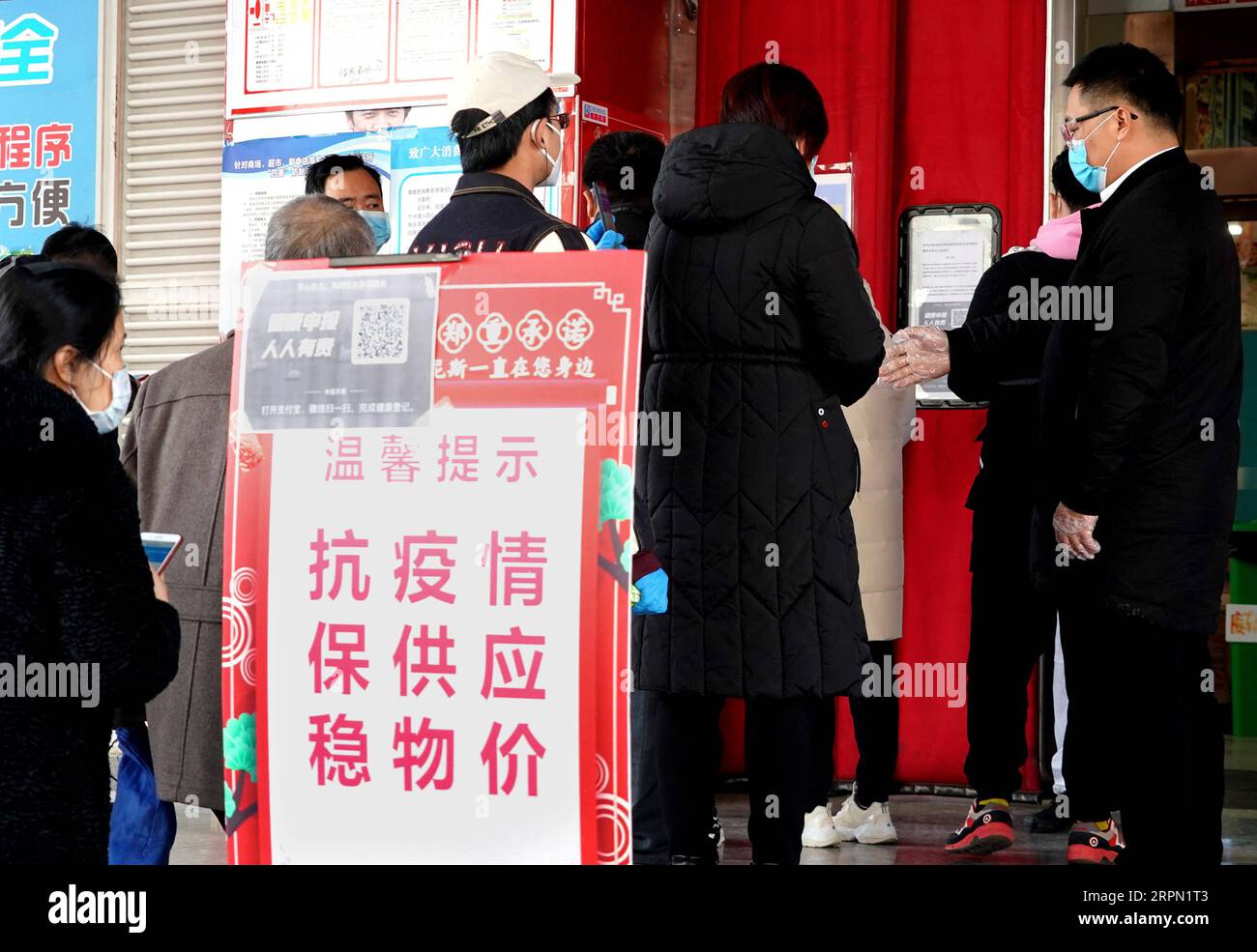 200220 -- ZHENGZHOU, 20. Februar 2020 -- Bewohner stehen an, um einen QR-Code an einem Eingang zu einem Supermarkt in Zhengzhou, der zentralchinesischen Provinz Henan, 19. Februar 2020 zu scannen. Die Stadt Zhengzhou in der Provinz Henan hat am Mittwoch ein QR-Code-System eingeführt, das mit dem System zur Registrierung von Gesundheitszuständen für Wohngemeinschaften verbunden ist. Bewohner der Stadt können jetzt QR-Codes verwenden, um den Transport zu nehmen und einzukaufen. Alle Informationen werden gesammelt und an eine integrierte Datenplattform zur Prävention und Bekämpfung von Epidemien in Echtzeit übermittelt, um den Ausbruch des Romans zu bekämpfen Stockfoto