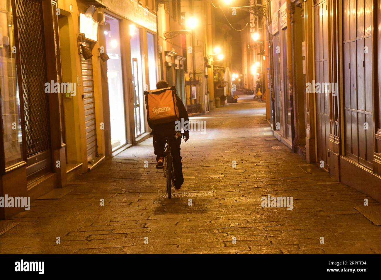 News Bilder des Tages 200321 -- BOLOGNA ITALIEN, 21. März 2020 Xinhua -- Ein Lebensmittellieferant fährt Ein Fahrrad in Bologna, Italien, 21. März 2020. Italien meldete am Samstag 6.557 neue Coronavirus-Fälle und erhöhte die Gesamtzahl auf 53.578, seit die Pandemie erstmals am 21. Februar in seinem Norden ausbrach, gemäß den neuesten Daten, die von der für den COVID-19-Notstand zuständigen Katastrophenschutzabteilung bereitgestellt wurden. Foto von Gianni Schicchi/Xinhua ITALY-BOLOGNA-COVID-19-CASES PUBLICATIONxNOTxINxCHN Stockfoto