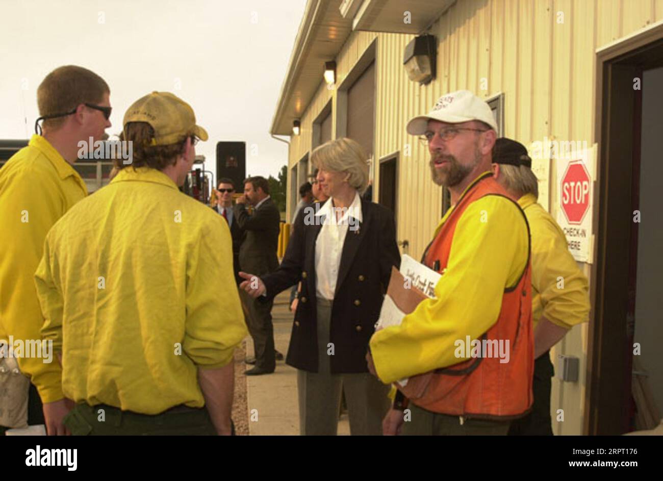 Secretary Gale Norton, Center, unterhielt sich mit Feuerwehrleuten während eines Besuchs des Brandgeschehens am Battle Creek im Pennington County in den Black Hills von South Dakota zu Gesprächen mit Bundes-, Staats-, lokalen Beamten und Feuerwehrleuten Stockfoto