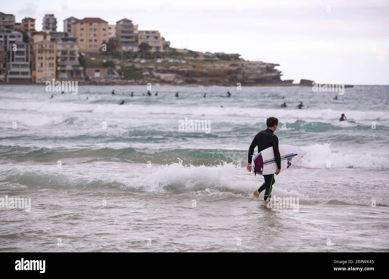 200428 -- SYDNEY, 28. April 2020 -- Ein Surfer spaziert am Bondi Beach in Sydney, Australien, am 28. April 2020 ins Wasser. Hunderte Aussies strömten am Dienstag ins Wasser, als der berühmte Bondi Beach für Surfer und Schwimmer wieder geöffnet wurde, nachdem er aufgrund von COVID-19 geschlossen wurde. AUSTRALIEN-SYDNEY-COVID-19-BEACH BaixXuefei PUBLICATIONxNOTxINxCHN Stockfoto