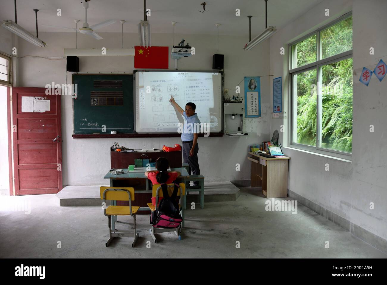 200910 -- FUZHOU, 10. September 2020 -- Liu Xisheng, ein 58-jähriger Lehrer der Danyang Primary School, unterrichtet den Zweitklässler Liu Zhixin Chinese in der Hongxing Township des Yongtai County, südöstliche Provinz Fujian, 8. September 2020. Libing, Danyang und Rongxin, 20 Kilometer von der Innenstadt von Yongtai County entfernt, sind drei Grundschulen in Mikrogröße. In der Libing Primary School ist der Erstklässler Xu Jiayi der einzige Schüler. Sie entschied sich, in der Schule in der Nähe ihres Hauses zu studieren. Um Xus Traum vom Studium zu erfüllen, behielt die örtliche Behörde die Schule und beauftragte Huang Lizhu, der Minnan Normal abschloss Stockfoto