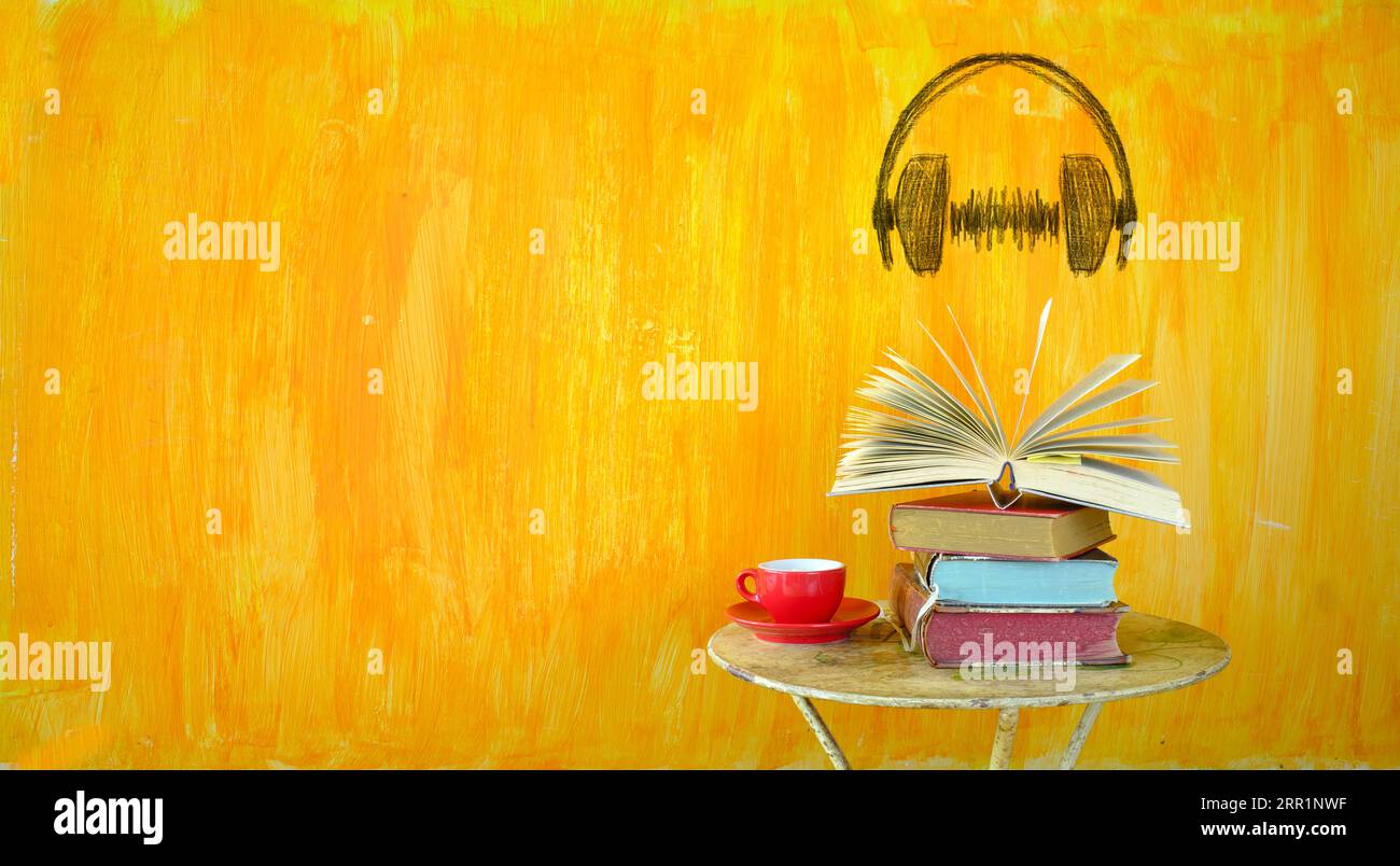 Audio-Buch-Konzept mit Haufen von Büchern und Zeichnung eines generischen Kopfhörers, negativ-Raum-Technik, freier Kopienraum Stockfoto