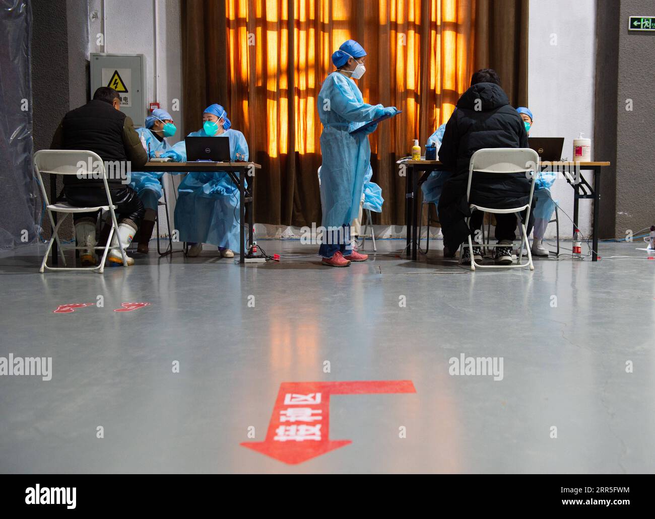 210106 -- PEKING, 6. Januar 2021 -- die Mitarbeiter bestätigen und registrieren die von Personen unterzeichneten Einwilligungsschreiben, die im Begriff sind, COVID-19-Impfungen an einer Impfstelle im Bezirk Chaoyang, Peking, Hauptstadt von China, am 5. Januar 2021 zu erhalten. Zusammen mit mehr als 70 seiner Kollegen aus der Lebensmittelindustrie, Herr Wu, dessen Vorname aus Gründen des Datenschutzes weggelassen wurde, 40, bestieg er einen Shuttlebus, der sie am Dienstag gegen 13.00 Uhr zu einer Impfstelle brachte. Wu, der für ein Unternehmen arbeitet, das in den Bereichen Gebäck, Bäckerei und Kühlkette tätig ist, sagte, alle seine Kollegen seien ausgezeichnet Stockfoto