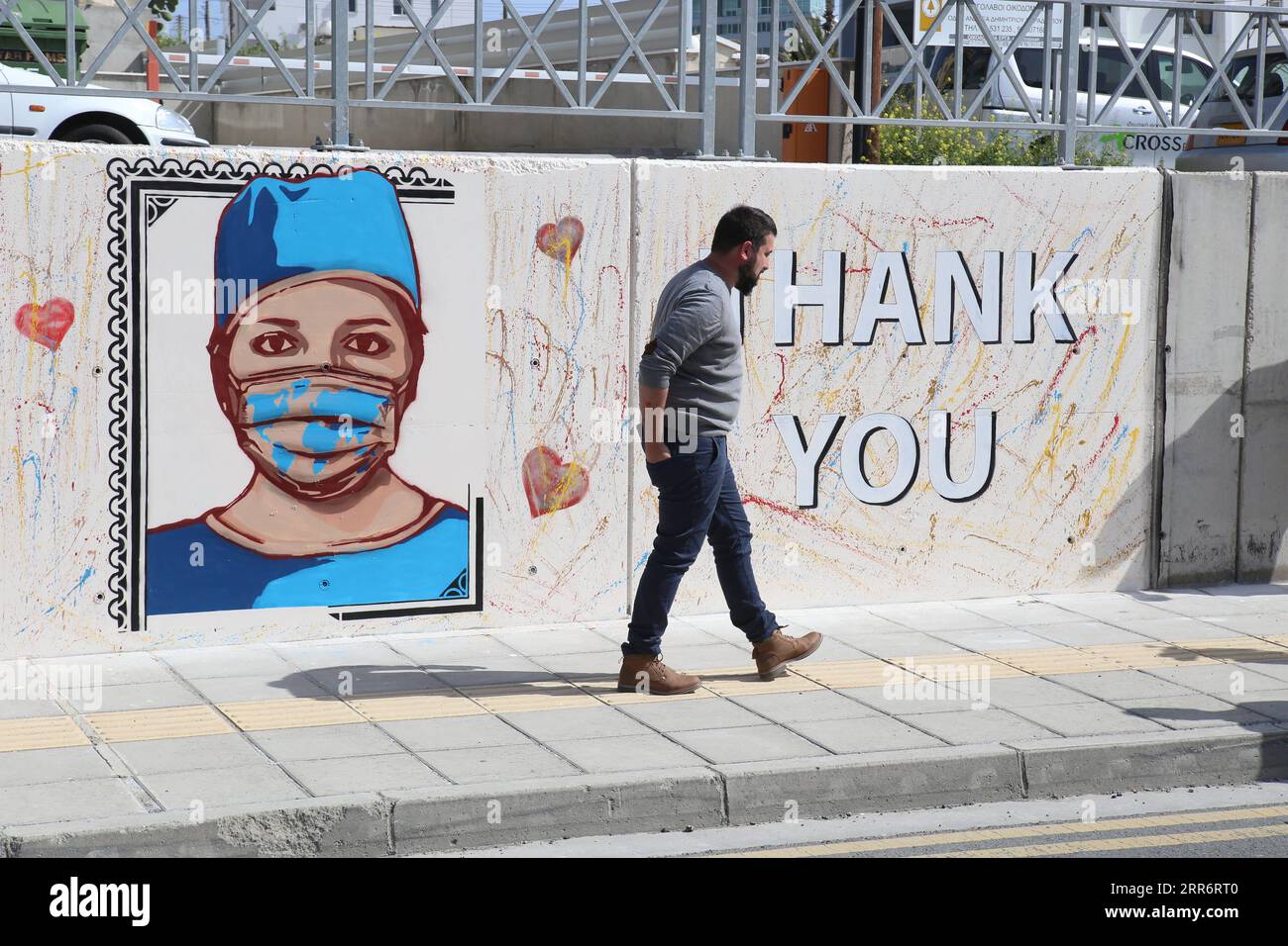 210226 -- LARNACA, 26. Februar 2021 -- Christos Kakoullis, ein zypriotischer Künstler, geht vor seinen Wandmalereien und zollt Gesundheitsfachkräften auf einem Boulevard in Larnaca, Zypern, 26. Februar 2021 Tribut. Foto von /Xinhua CYPRUS-LARNACA-MURAL-HEALTH WORKERS GeorgexChristophorou PUBLICATIONxNOTxINxCHN Stockfoto