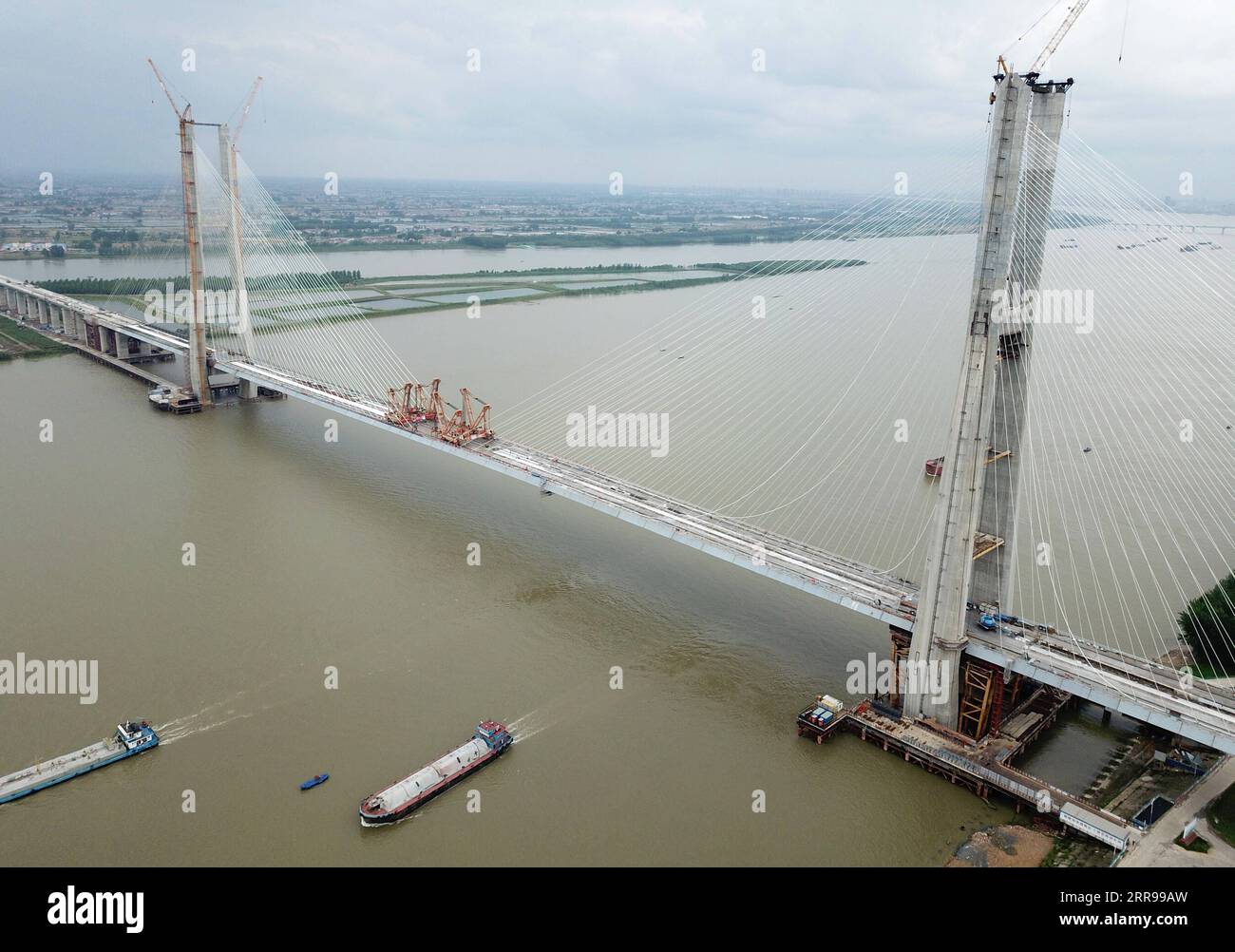 210603 -- WUHAN, 3. Juni 2021 -- Luftaufnahme aufgenommen am 3. Juni 2021 zeigt die Bianyuzhou Yangtze River Bridge an der Grenze der zentralchinesischen Provinz Hubei und der ostchinesischen Provinz Jiangxi. Die Brücke verbindet den Bezirk Huangmei der zentralchinesischen Provinz Hubei mit der Stadt Jiujiang der ostchinesischen Provinz Jiangxi und ist Teil der Anqing-Jiujiang Railway. Die Bahnstrecke hat eine geplante Geschwindigkeit von 350 Stundenkilometern für die beiden Hochgeschwindigkeitsstrecken und 200 Stundenkilometern für die beiden anderen reservierten Personen- und Güterstrecken. CHINA-ANQING-JIUJIANG-RAILWAY-BIANYUZHOU YANGTZE RIVER BRIDGE CLOSURE CN Stockfoto