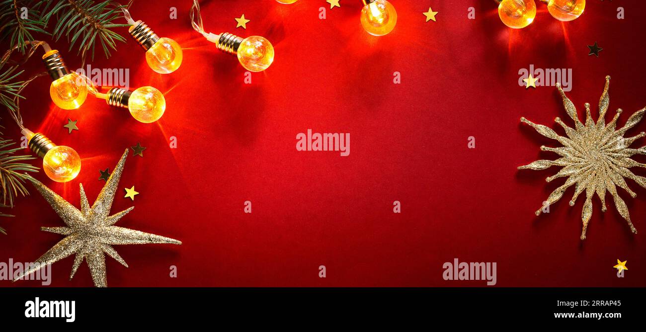 Weihnachtsbanner oder Grußkartenhintergrund mit weihnachtslicht und Dekoration auf rotem Hintergrund; Weihnachtsrahmenrahmen Stockfoto