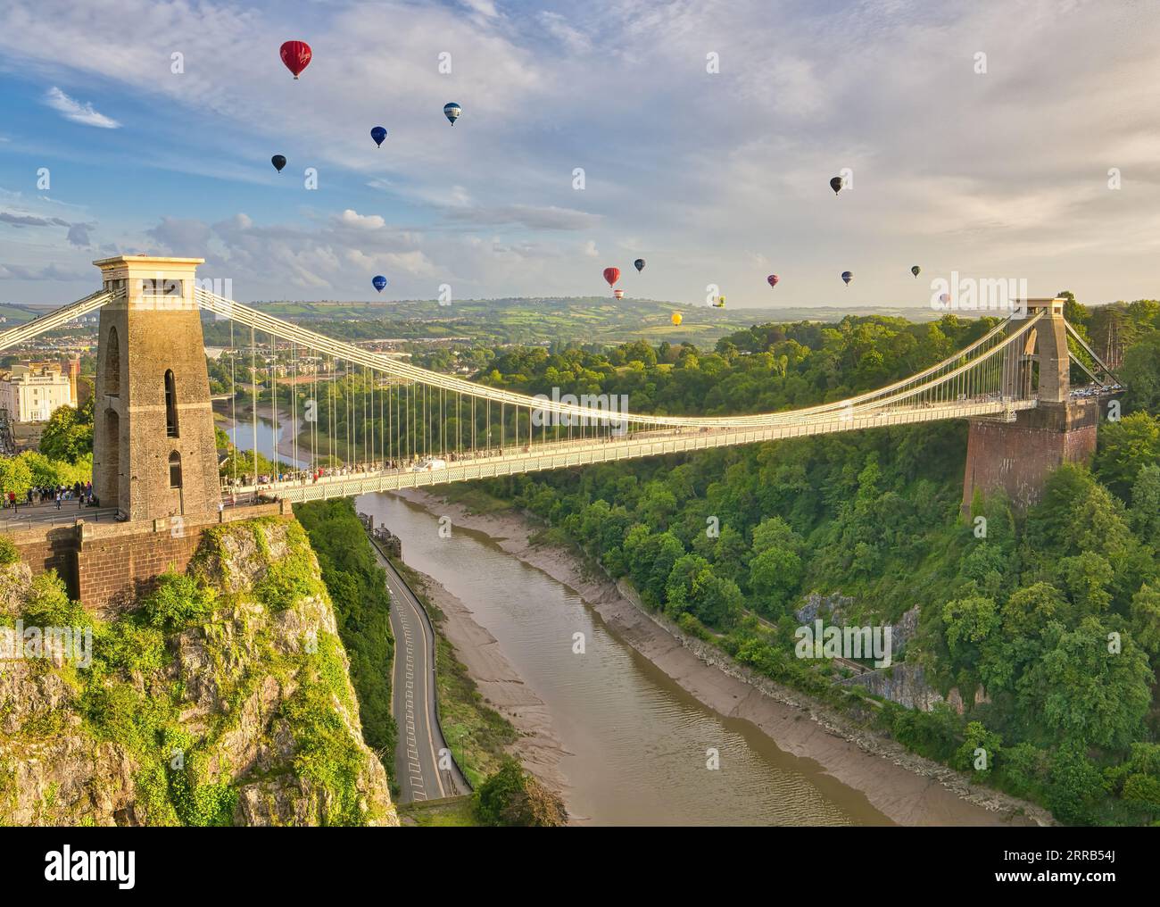 Der Massenaufstieg bei der Bristol International Balloon Fiesta, während farbenfrohe Heißluftballons über die Clifton Suspension Bridge in die Luft fliegen. Stockfoto