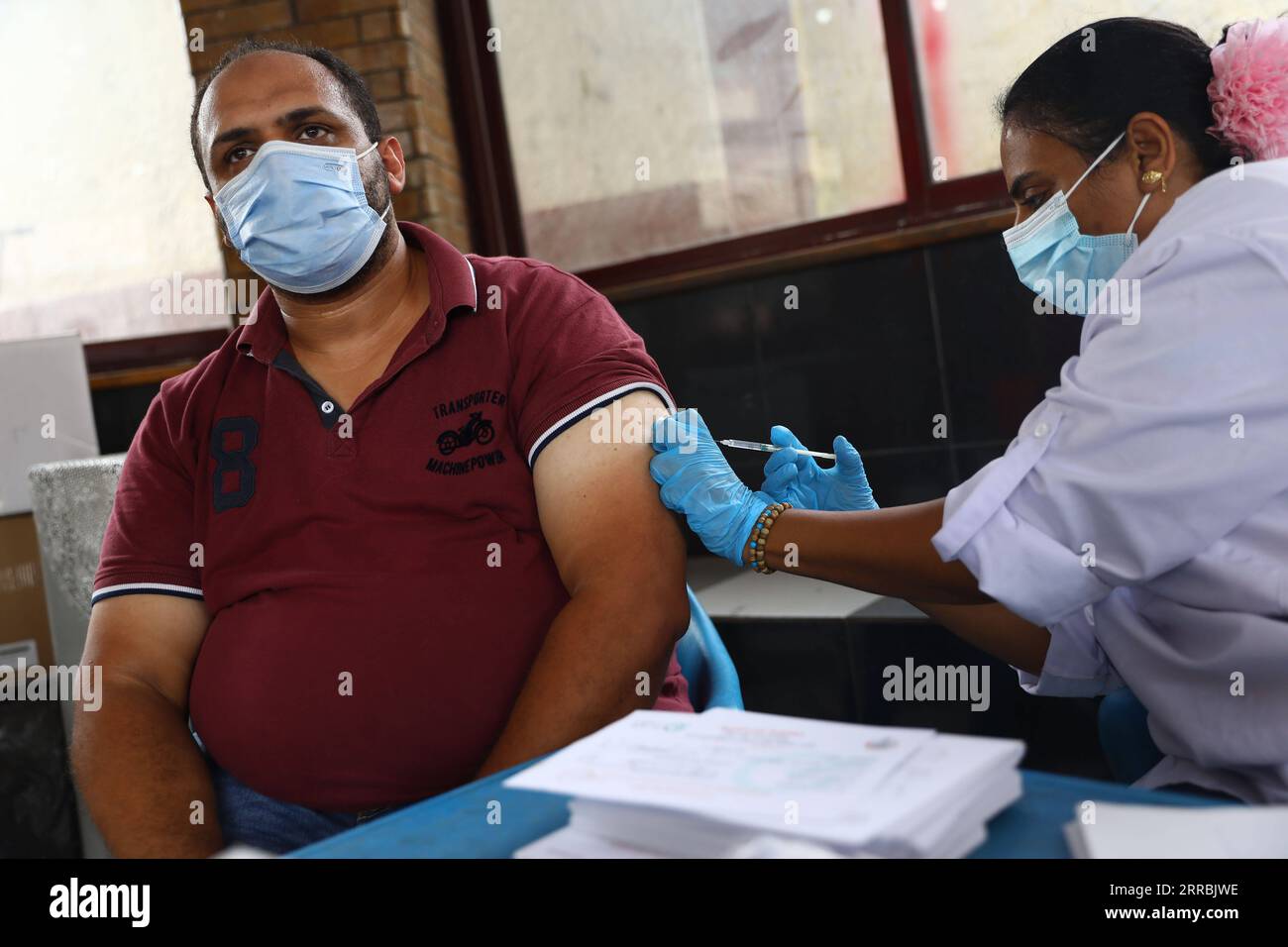 210926 -- KAIRO, 26. September 2021 -- Ein Arzt impfen einen Mann im Rod El Farag Jugendzentrum in Kairo, Ägypten, 26. September 2021. Ägypten eröffnete am Sonntag ein Jugendzentrum in jeder Provinz, um Menschen mit COVID-19-Impfstoff zu impfen, um seine Impfkampagne voranzutreiben. ÄGYPTEN-KAIRO-JUGENDZENTRUM-IMPFUNG AhmedxGomaa PUBLICATIONxNOTxINxCHN Stockfoto