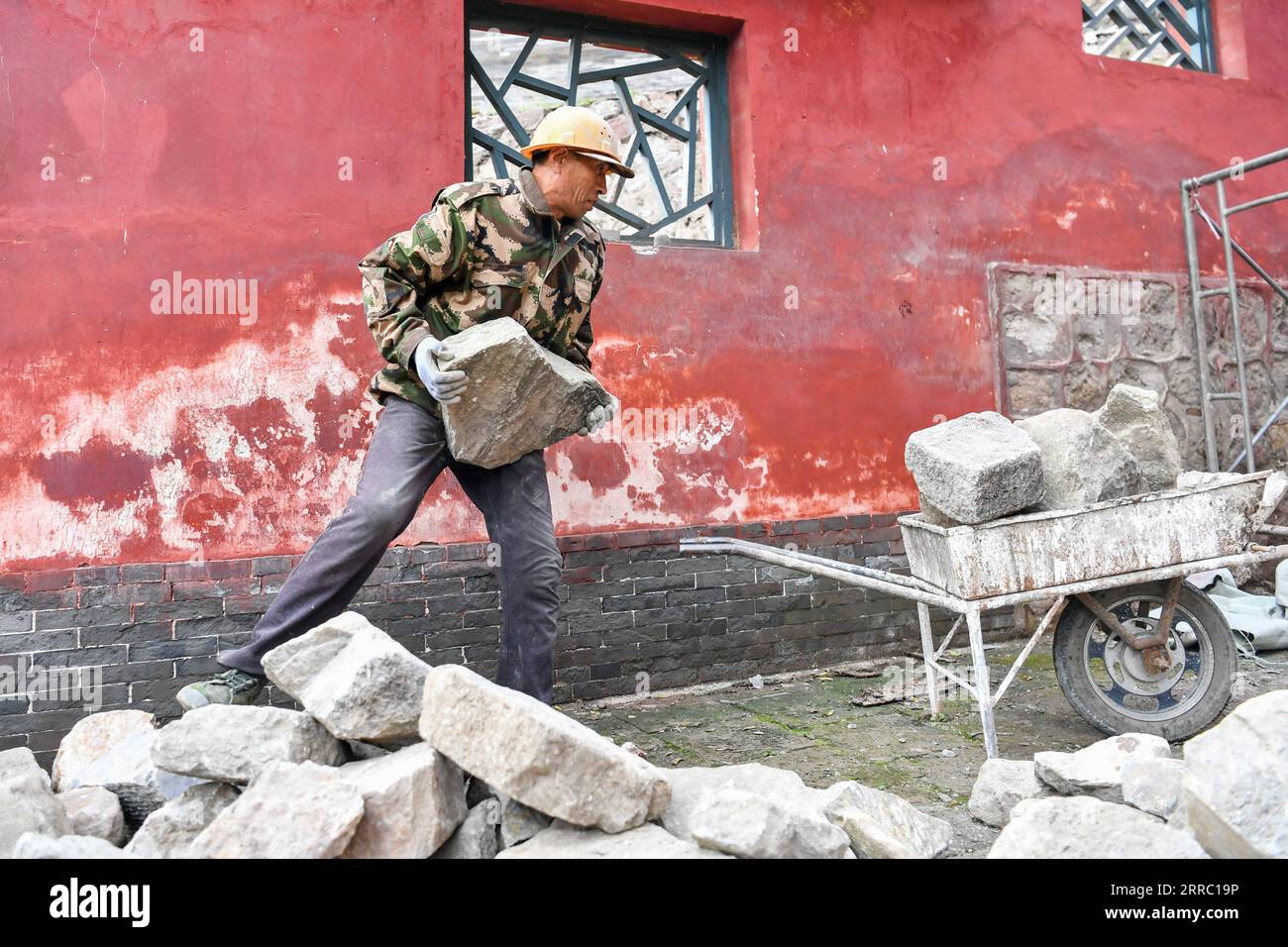 211012 -- TAIYUAN, 12. Oktober 2021 -- Ein Arbeiter zieht Material im Jinci Temple Museum in Taiyuan, Hauptstadt der nordchinesischen Provinz Shanxi, 12. Oktober 2021 um. Shanxi wurde kürzlich von ständigen Regenfällen heimgesucht, die in mehreren Teilen der Provinz zu Überschwemmungen führten. Mehr als 1.000 Kulturdenkmäler und Gebäude haben durch das extreme Wetter strukturelle Schäden erlitten. Die örtliche Behörde für Kulturerbe führt Reparaturarbeiten an den Kulturrelikten durch, die bei der jüngsten Überschwemmung beschädigt wurden. CHINA-SHANXI-TAIYUAN-HOCHWASSERREPARATUR CN CAOXYANG PUBLICATIONXNOTXINXCHN Stockfoto