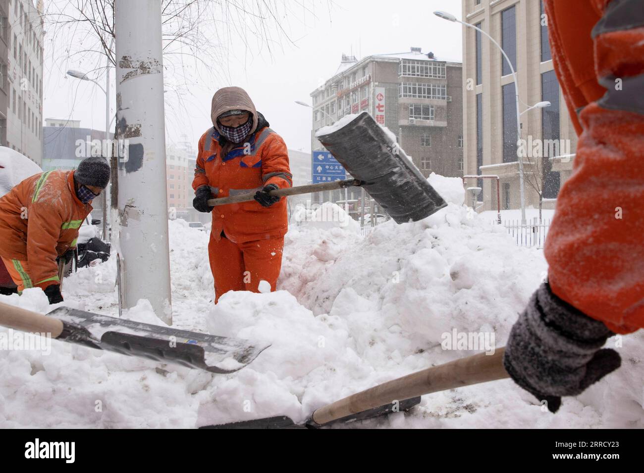 211122 -- JIXI, 22. November 2021 -- Sanitäter räumen Schnee von einer Straße in der Stadt Jixi, nordöstliche chinesische Provinz Heilongjiang, 22. November 2021. Schwere Schneefälle trafen in letzter Zeit viele Teile von Heilongjiang. Mitarbeiter verschiedener Sektoren trotzen eisigen Böen und Schneeflocken, um die normale Verfügbarkeit wesentlicher öffentlicher Dienste zu gewährleisten. CHINA-HEILONGJIANG-BLIZZARD CN ZhangxTao PUBLICATIONxNOTxINxCHN Stockfoto