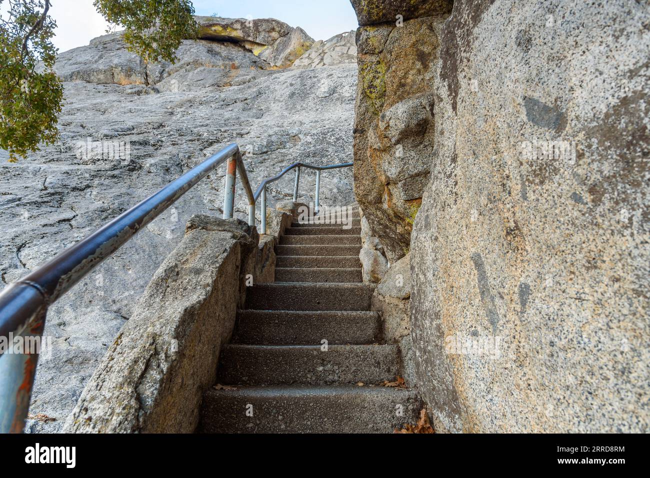 Leere schmale Treppe mit Metallgeländern, die auf einen felsigen Berggipfel führen Stockfoto