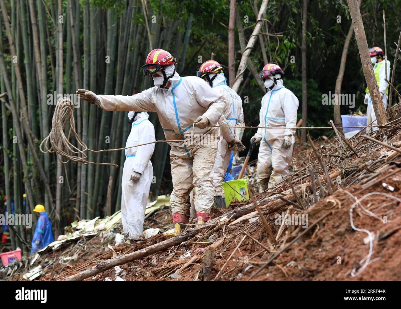 220327 -- TENGXIAN, 27. März 2022 -- Ein Retter wirft ein Sicherheitsseil an einen Kollegen auf der Flugzeugabsturzstelle im Tengxian County, südchinesische autonome Region Guangxi Zhuang, 26. März 2022. Alle 132 Menschen an Bord des Flugzeugs der China Eastern Airlines, das am Montag in der autonomen Region Guangxi Zhuang in Südchina abstürzte, waren tot, wie ein Beamter am Samstag mitteilte. Die nationale Notfallzentrale für den Flugzeugunglück der China Eastern Airlines Flug MU5735 am 21. März gab die Ankündigung auf einer Pressekonferenz am späten Abend am Samstag nach sechs Tagen voller Such- und Rettungsbemühungen bekannt. CH Stockfoto