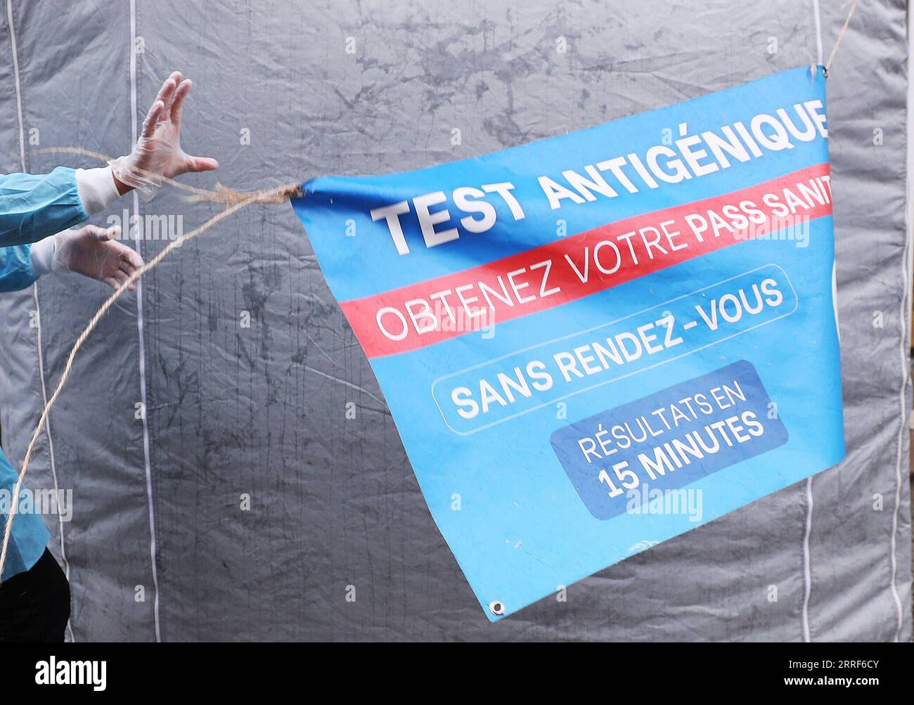 220401 -- PARIS, 1. April 2022 -- Ein Angestellter des medizinischen Personals justiert ein Zeichen im Wind an einem schnellen COVID-19-Testzelt in Paris, Frankreich, 1. April 2022. Das französische Innenministerium kündigte am Mittwoch ein Gesundheitsprotokoll für die Wahllokale während der bevorstehenden Präsidentschaftswahlen am 10. Und 24. April an. Nach Angaben des ministeriums ist der Impfpass oder ein negatives COVID-19-Testergebnis für diejenigen, die Wahllokale betreten, nicht erforderlich. Frankreich meldete am Dienstag 217.480 COVID-19-Fälle, die höchste tägliche Zahl seit der Aufhebung der meisten COVID-19-Beschränkungen durch das Land am 14. März. Auf Wedne Stockfoto