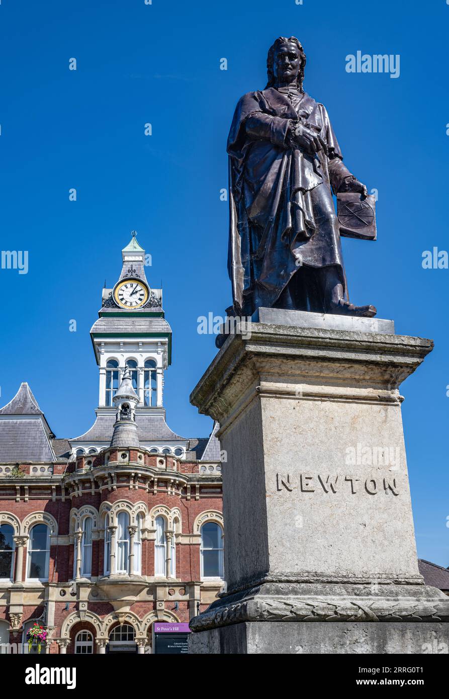 St Peters Hill Grantham Lincolnshire – Statue von Sir Isaac Newton, der in der Stadt zur Schule ging, vor einem Sommerhimmel mit der Town Guildhall im Hintergrund Stockfoto