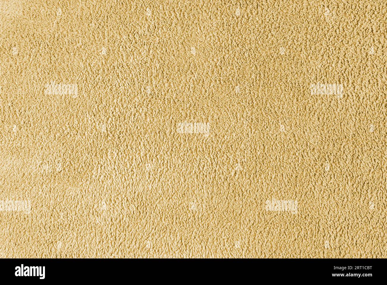 Frottee, gelber Handtuchhintergrund. Weiches, flauschiges Textil-Bad- oder Strandhandtuchmaterial. Draufsicht, Nahaufnahme. Stockfoto