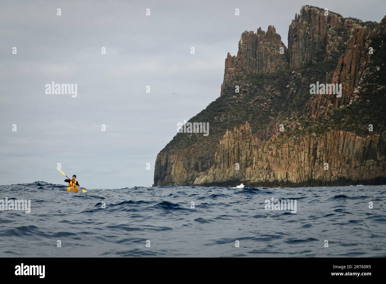 Ein Seekajaker paddelt um Cape Pillar, Tasman Peninsula, Tasmanien, Australien. Stockfoto