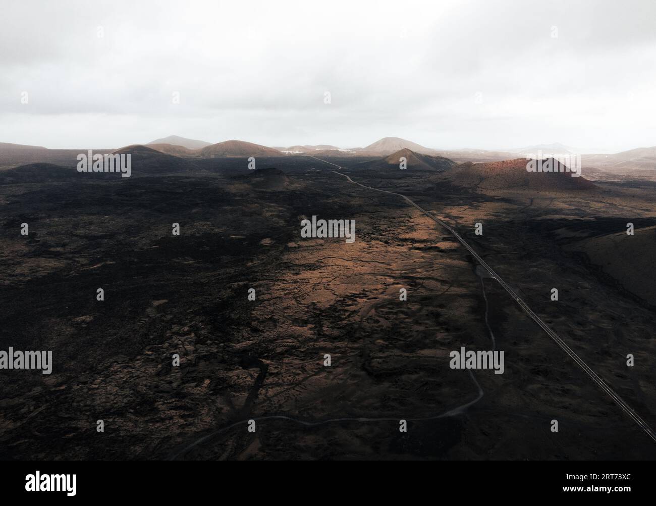 Dramatisches Landschaftsbild - Vulkane auf Lanzarote bei Sonnenuntergang. Moody and Dark Photo - Panorama der schwarzen Lavainsel Lanzarote. Stockfoto