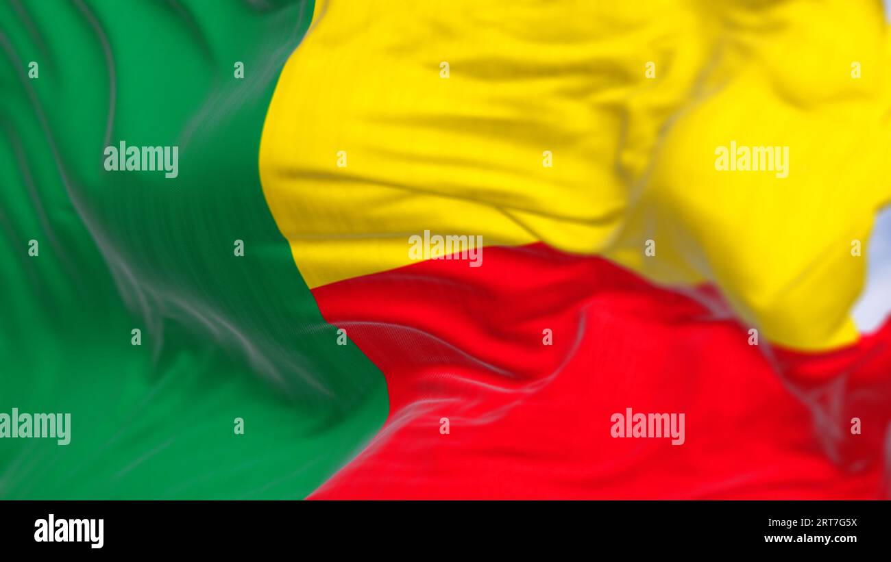 Nahaufnahme des Wehens der Nationalflagge von Benin. Zwei horizontale gelbe und rote Bänder auf der Fliegenseite und ein grünes vertikales Band an der Hebevorrichtung. 3D-Abbildung zu Stockfoto