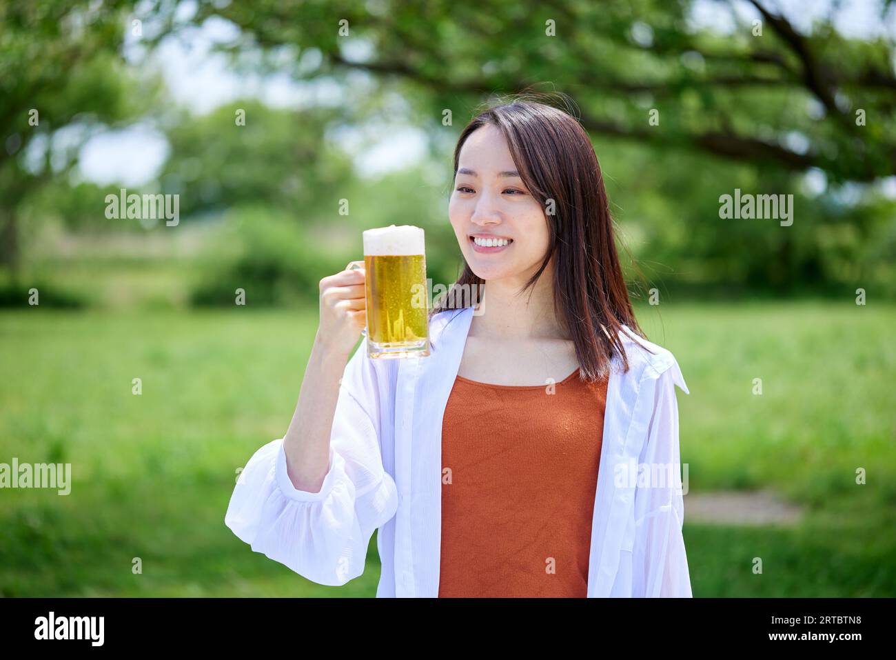 Japanische Frau trinkt Bier Stockfoto