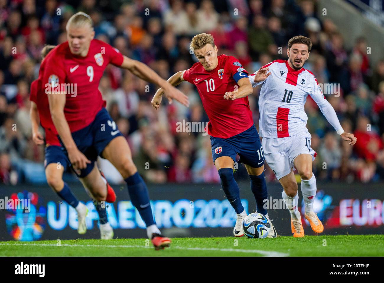 Oslo 20230912. Erling Braut Haaland und Martin Oedegaard gegen Georgiens Otar Kiteishvili während des Qualifikationsspiels zur Europameisterschaft zwischen Norwegen und Georgien im Ullevaal-Stadion. Foto: Fredrik Varfjell / NTB Stockfoto