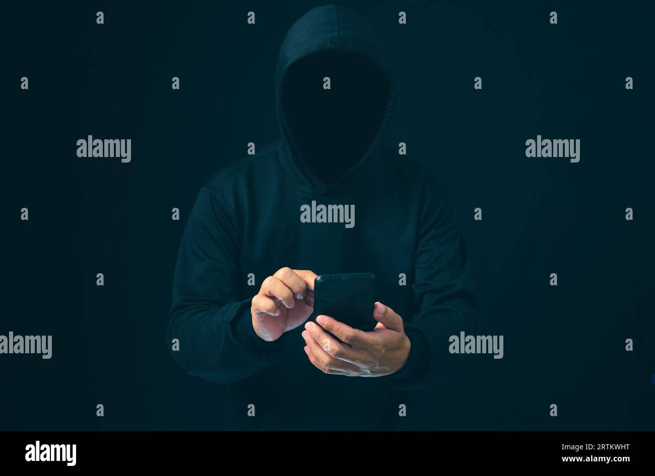 Hacker arbeiten im Dunkeln am Telefon. Das Konzept der Informationssicherheit im Internet und der Informationsspionage. Virenangriff. Hackerangriff. Stockfoto